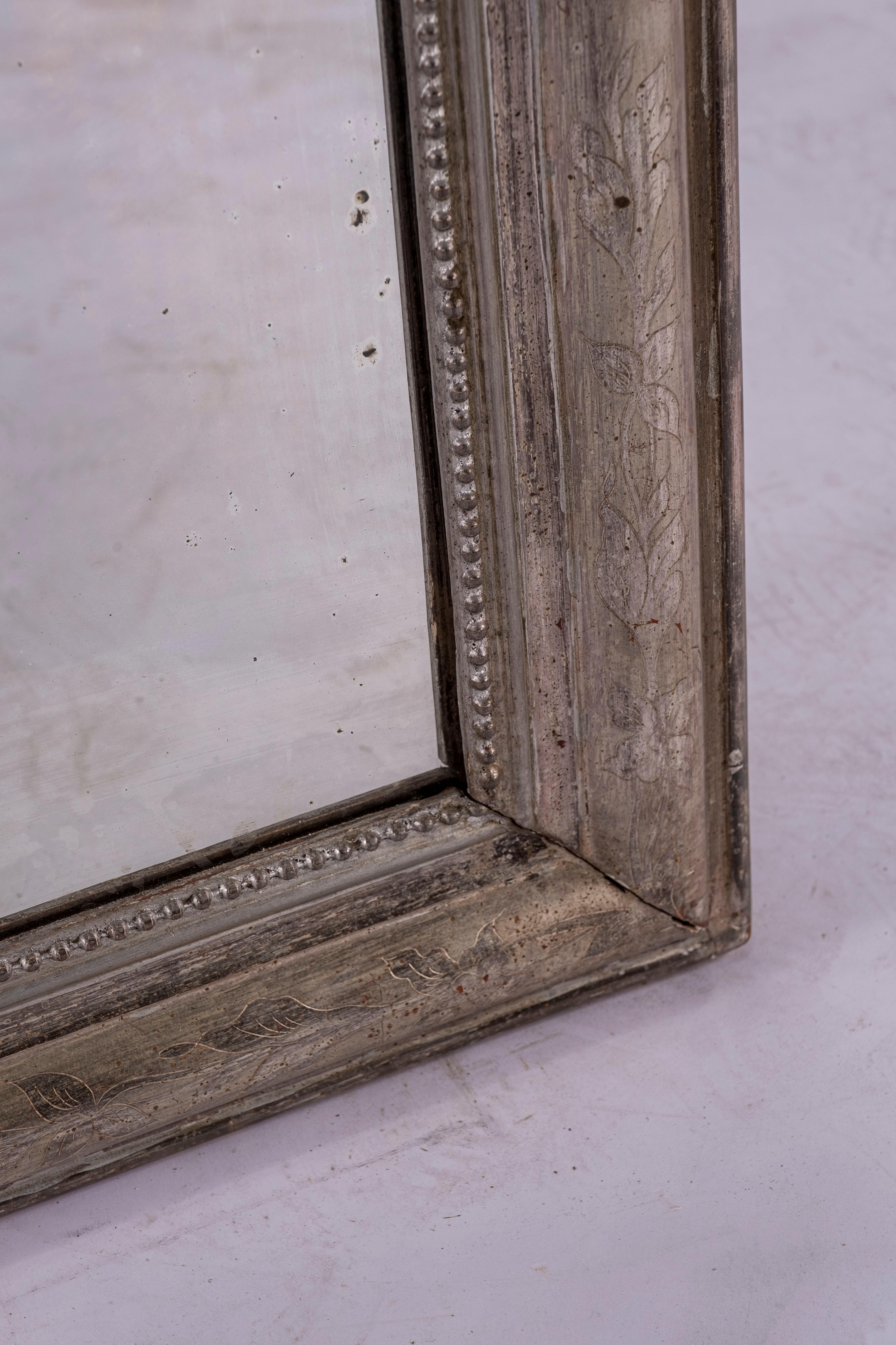 19th century silver Louis Philippe mirror with floral etching on wooden perimeter.