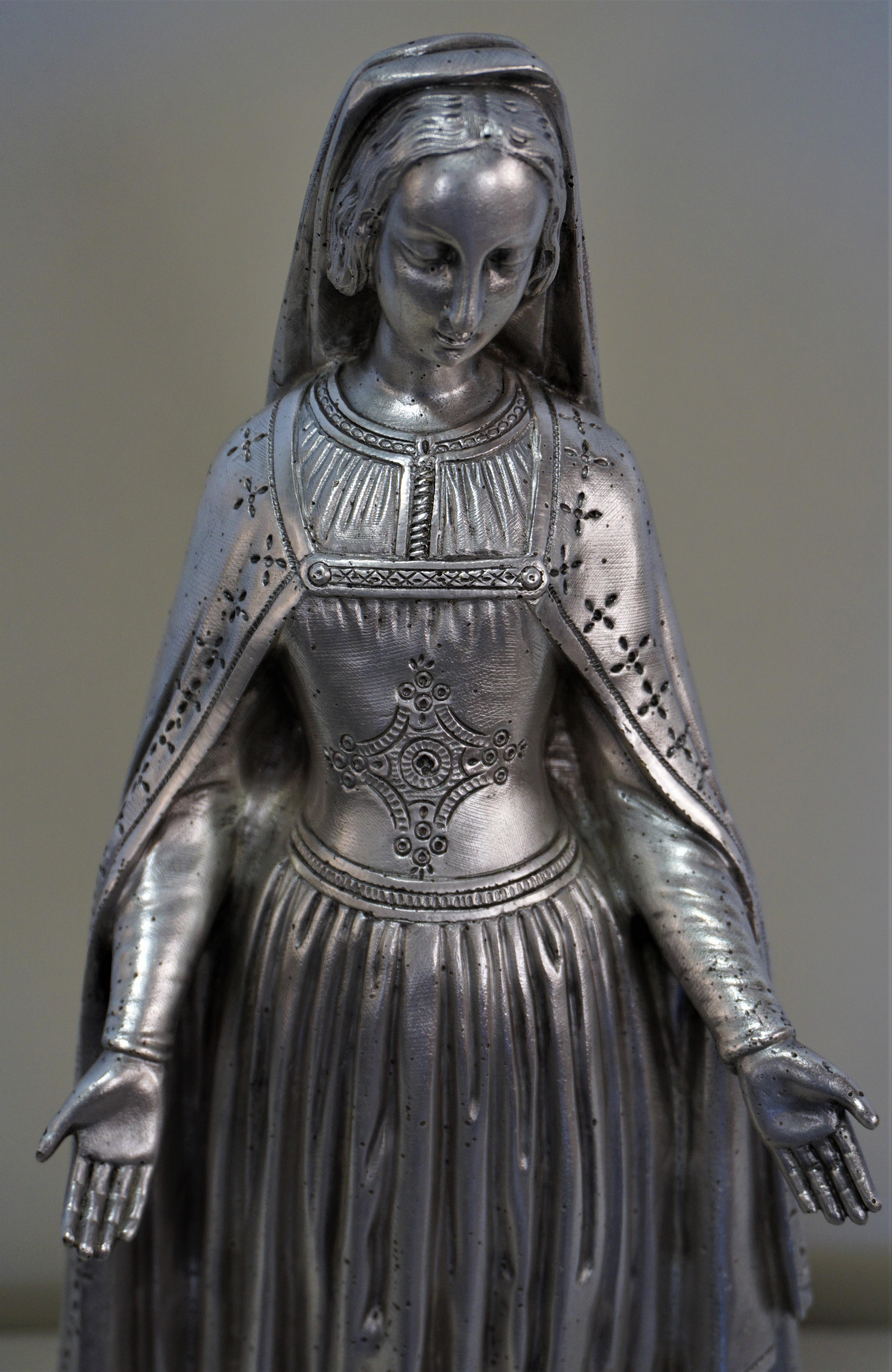 19th century Madonna at conquest standing on snake. Silver on bronze.