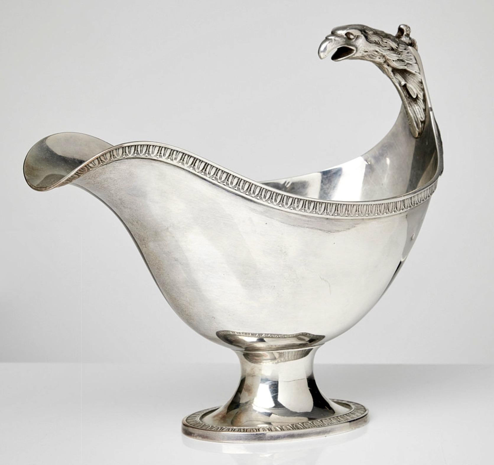 A nice 19th century silver sauce boat of empire model made in Paris. A well executed eagle head forming the handle. With makers stamp of  Paul Duhamel working 1832-1845 in Paris.
The eagle represent honesty, truth, majesty, strength, courage,