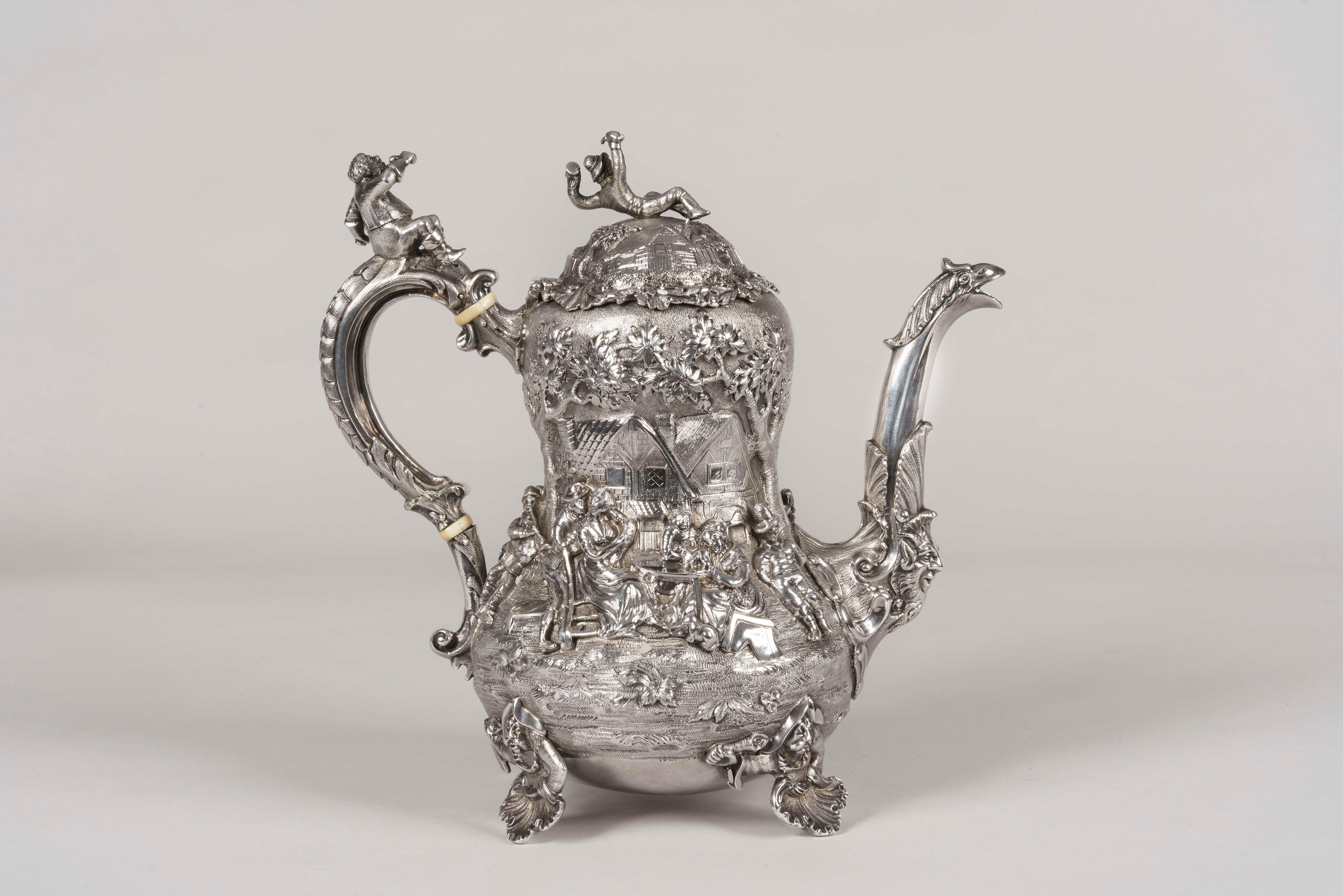 An exquisite tea & coffee service
Made by Joseph Angell

Assayed in London in 1852-1853, the solid silver 4-piece service in the manner of Edward Farrell decorated in high relief with scenes of merry-making and tavern interiors in the style of