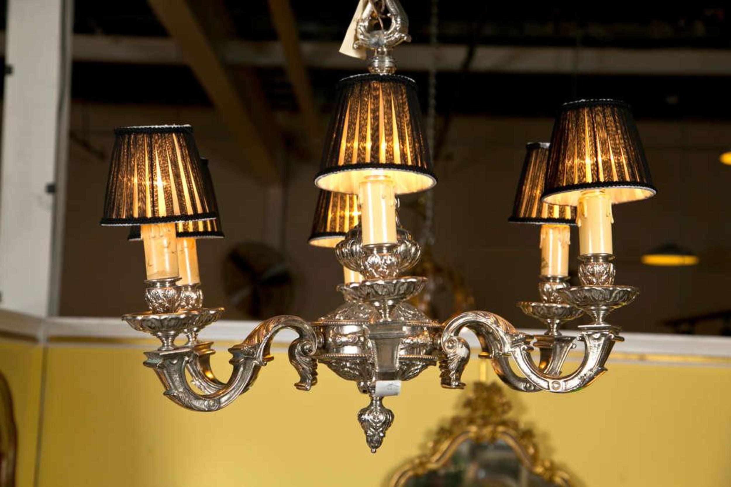 A finely cast six light silvered bronze chandelier. The center column leading to six arms all newly wired. The
finely Rococo frame all over decorated with scrolls and leaf design. When looking up front the table the bottom is wonderful crafted and