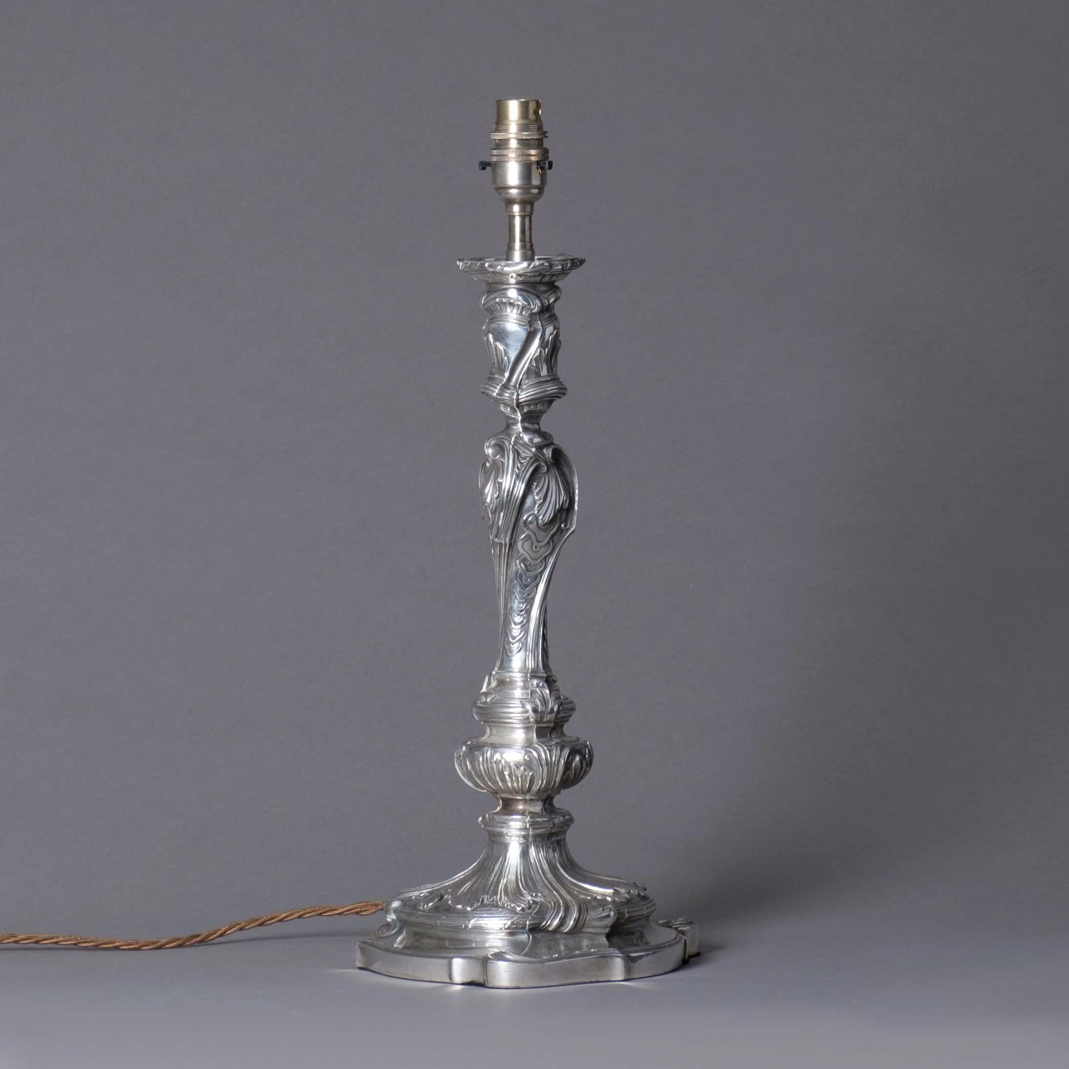 A silvered candlestick in the Louis XV Rococo manner, now mounted as a lamp base.

Height dimensions refer to height of pottery candlestick only.

Wired and tested for UK safety standards. This item can be re-wired for US, EU and worldwide
