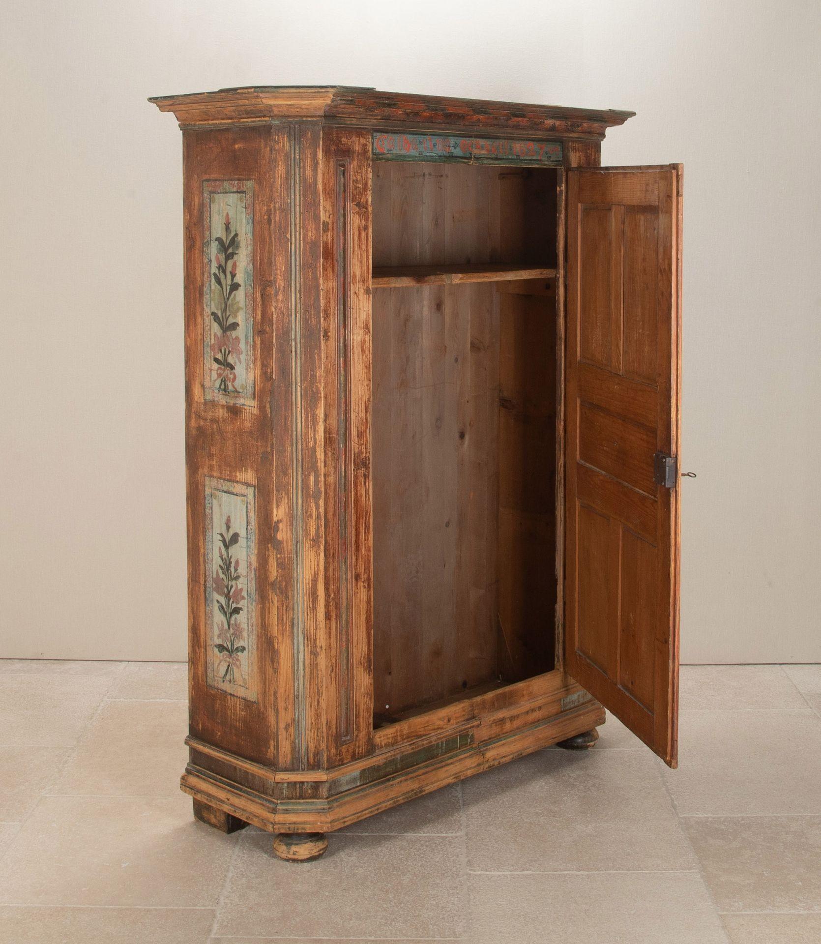 Lovely 19th Century Northern French single door pine armoire. With original painted floral decoration dated 1827. Single shelf to the interior.