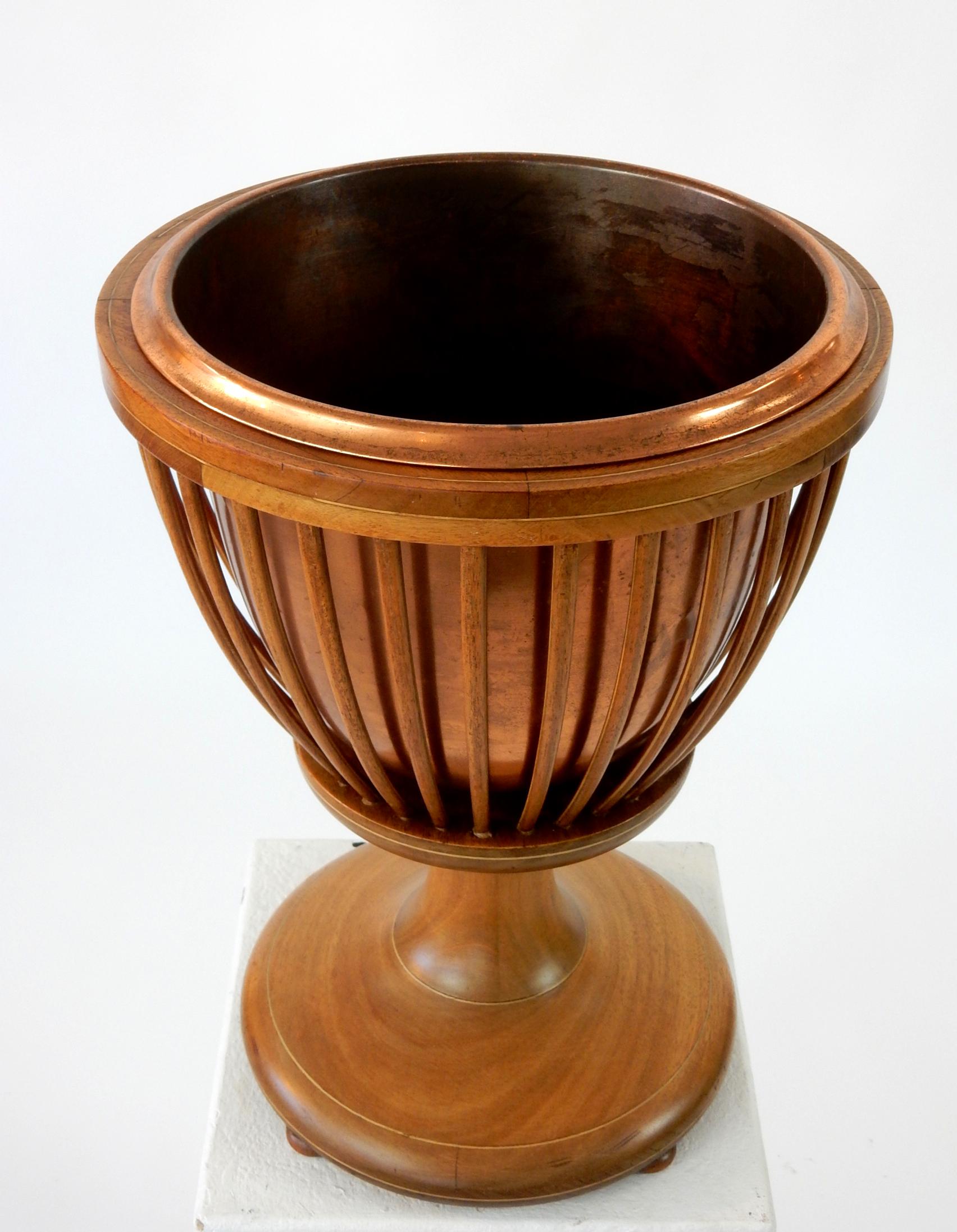 19th century slatted inlaid mahogany planter with copper liner.
Beautifully hand crafted piece. Unsigned but stamped 1795 on base.
Stands 19 inch tall x 14 inch wide.
