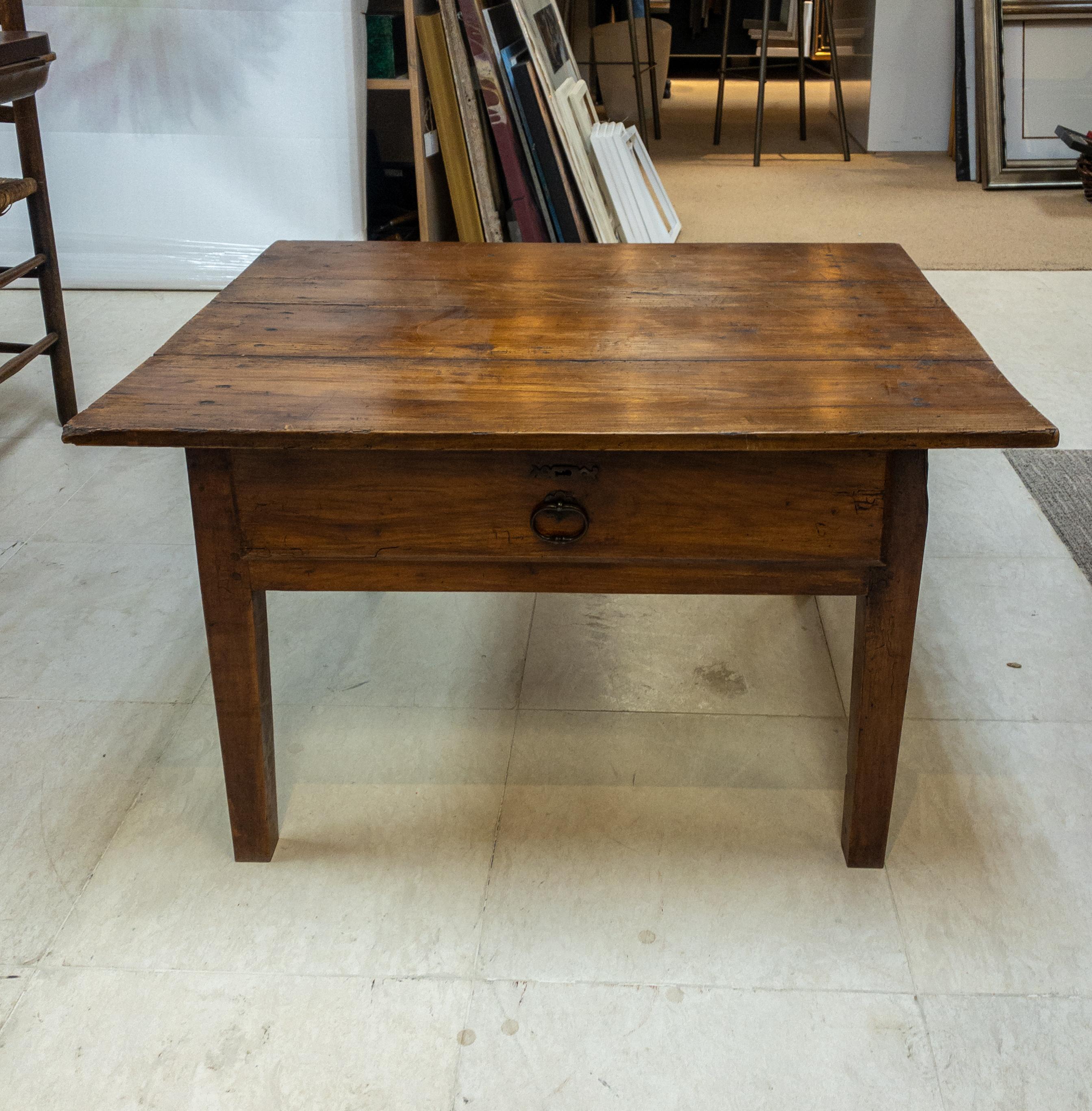 The 19th Century French Low Table epitomizes the fusion of practicality and elegance. Serving as a small yet versatile work table, it features a single drawer seamlessly incorporated into its design, providing convenient storage for essentials. With