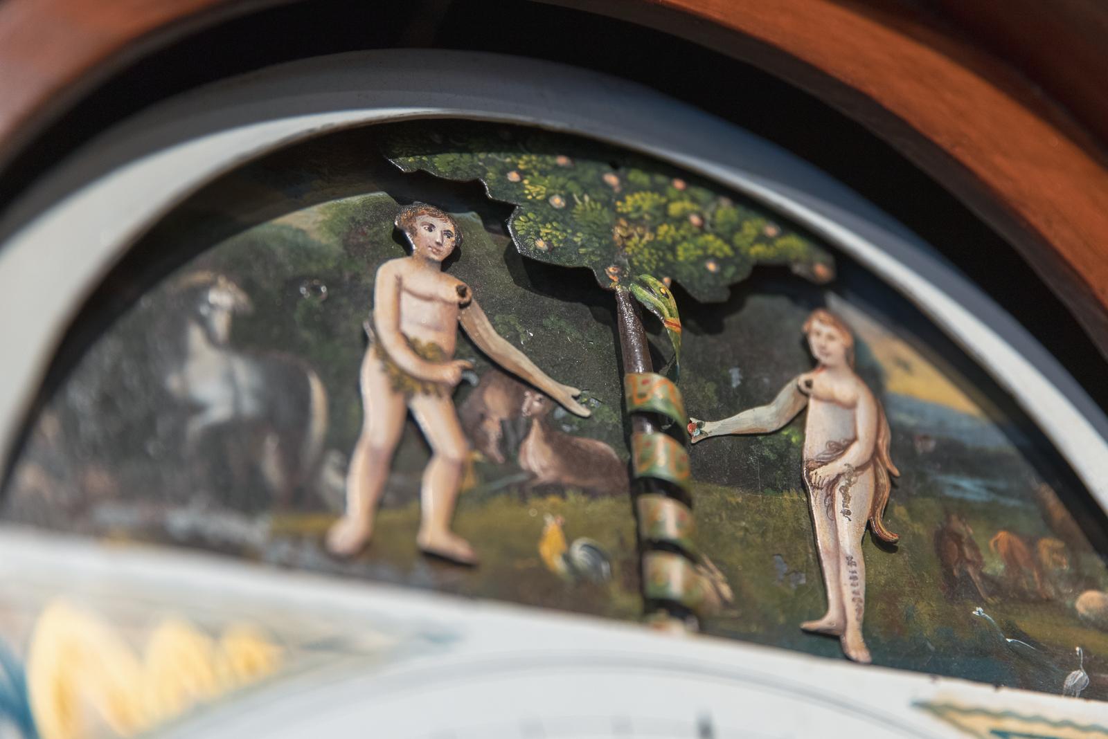 Very rare 8 day arch painted dial automata clock with striking on the hours on a single bell. To the arch the rare automata of moving Adam & Eve in the Garden of Eden, picking the Forbidden Fruit and in the background the serpent revolving around