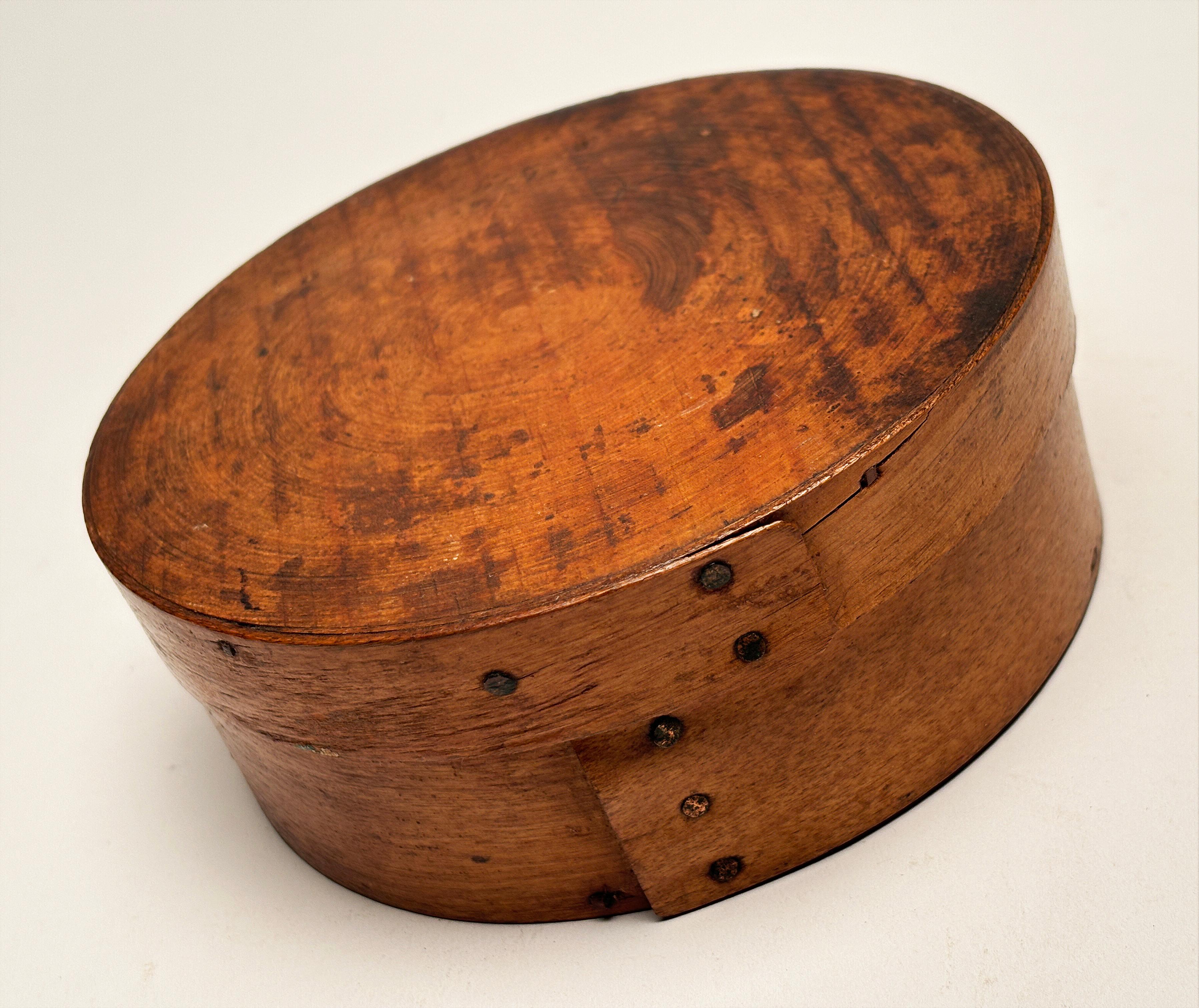 This beautifully constructed circular pantry box from the late 19th century is indeed a unique find. It's smaller size makes it particularly unusual. Typically found in one's pantry for storage, today, this piece might be found as a decorative