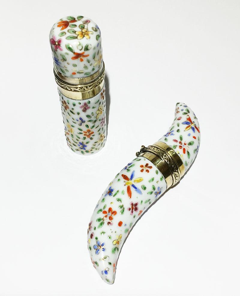 19th century small porcelain enameled scent perfume bottles

Porcelain enameled bottles with floral decor
The setting is not marked. The metal is silver and gold colored
The bottles has a cork and a glass stopper

The measurements are 8 and 11