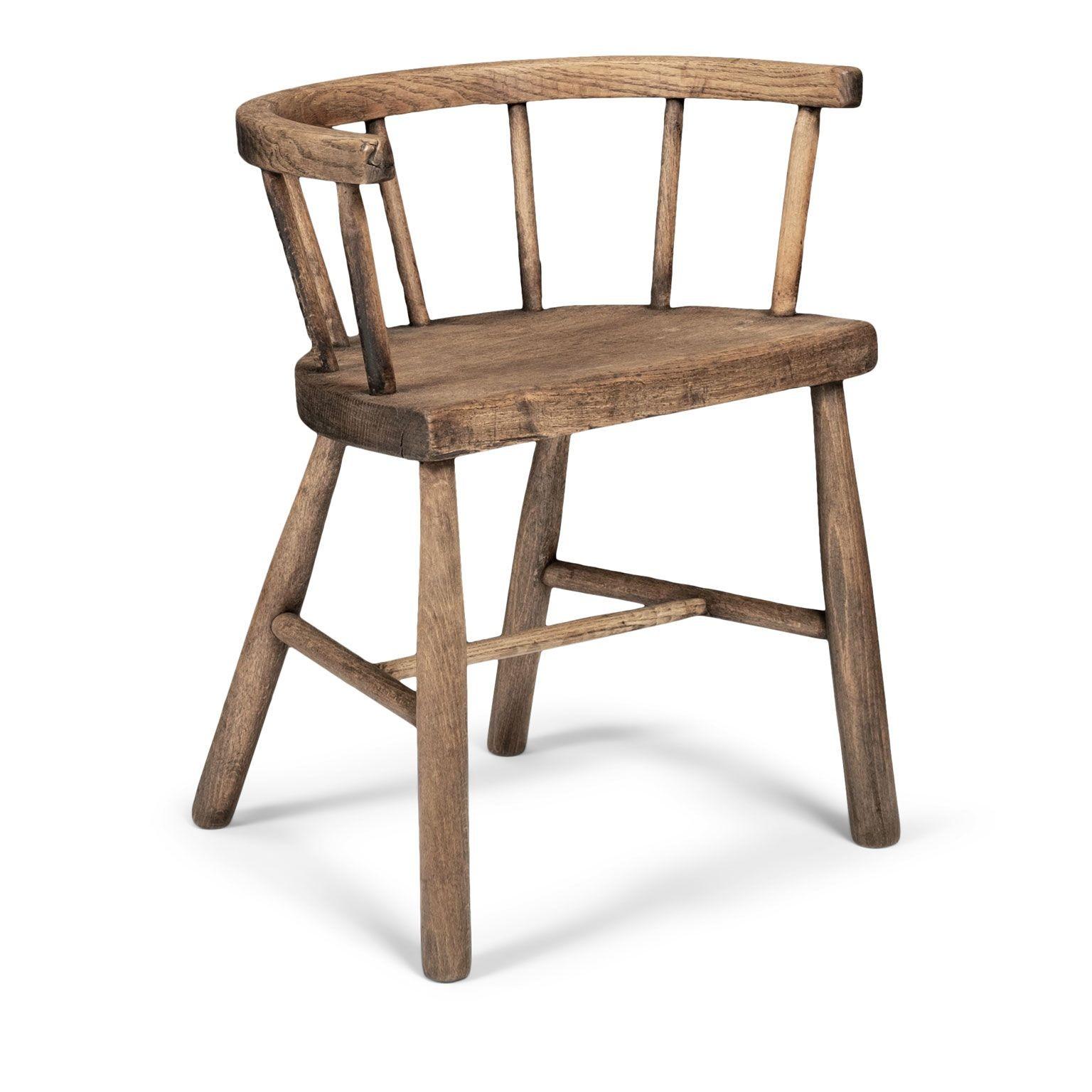 19th century small vernacular chair circa 1880-1909, England. Constructed in a mid-brown finished ash with spindle back and horseshoe-yoke. Functioned as a work stool or child's chair.

Note: Due to regional changes in humidity and climate during