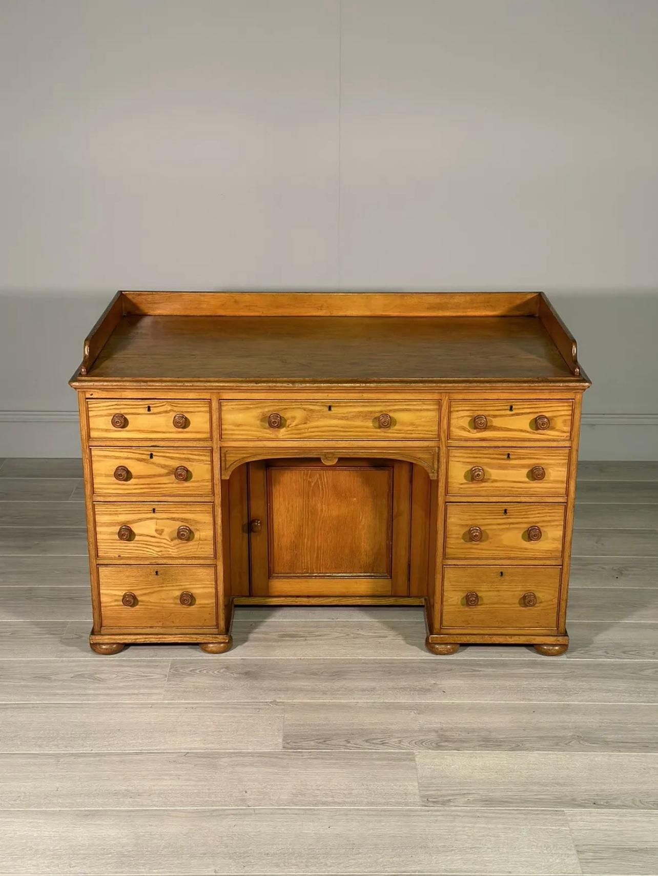 A fine quality kneehole desk dating to the late part of the 19th century. Made entirely out of solid ash with a lovely rich warm colour, the desk is in fantastic original condition even down to the oak lining paper to the drawer internals. A fine