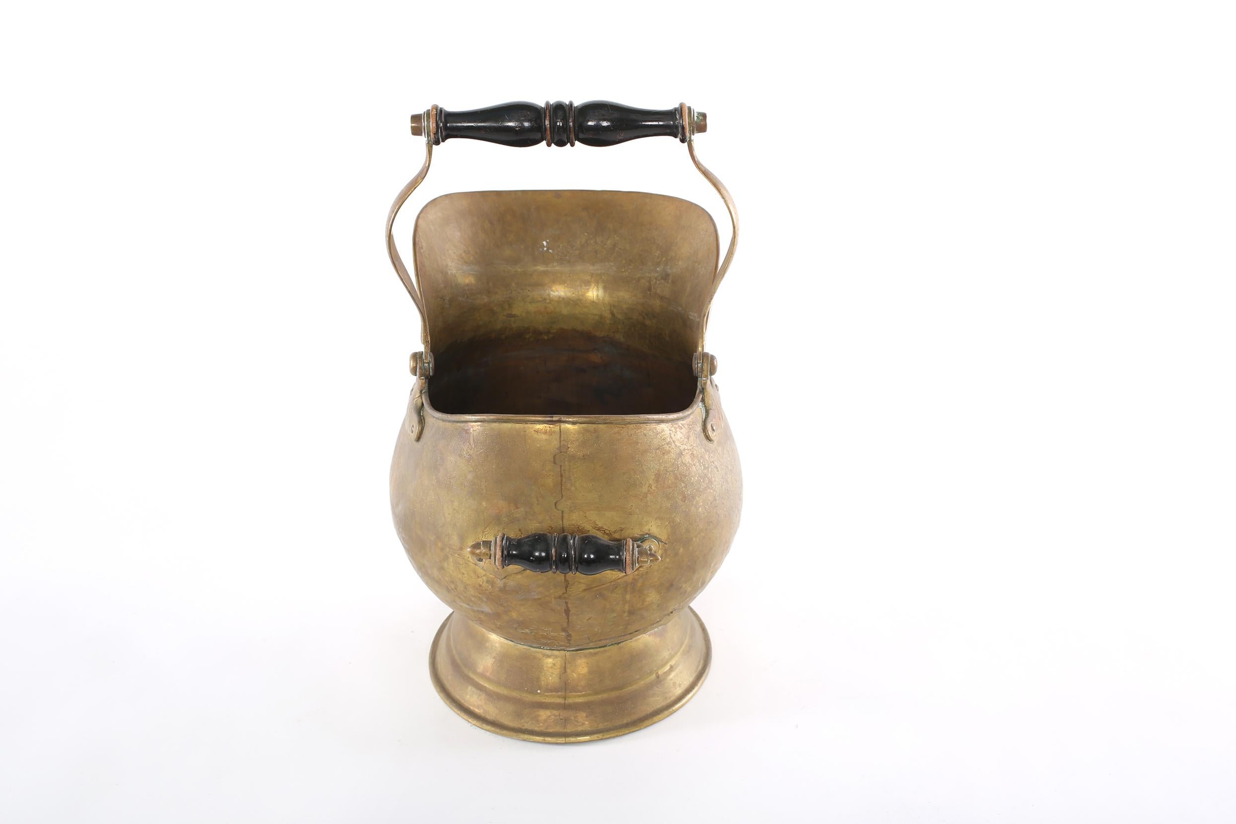 19th century Eastern European solid brass ash bucket / fire log holder with wood handles. The fire log is in good condition with age appropriate wear. Maker's mark undersigned. The log bucket stand about 17 inches tall to the top of the handle x 15