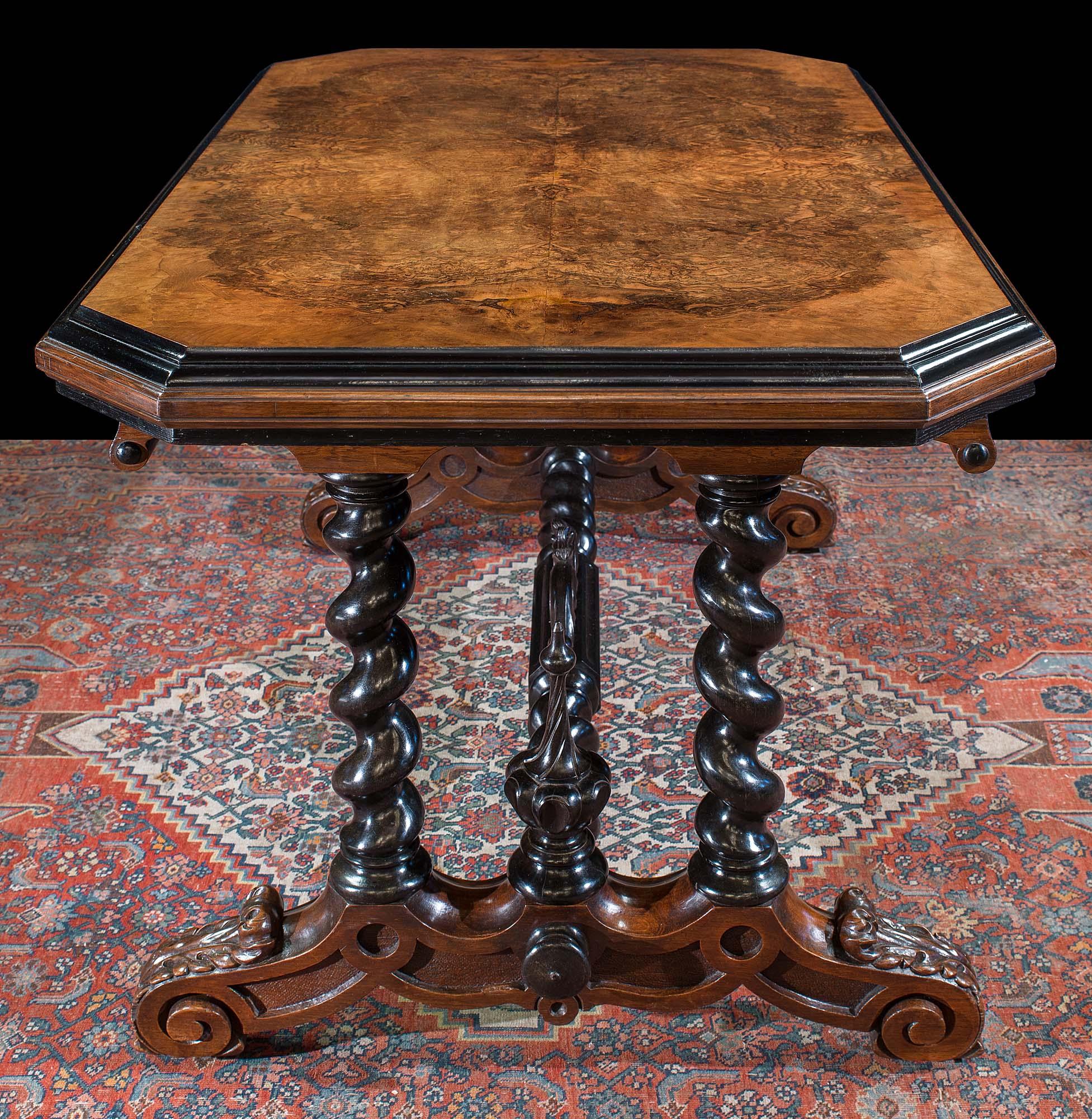 A superb Victorian walnut and solid ebony library table. This outstanding table is made especially rare by having solid ebony legs, stretcher and finials. The beautifully carved Solomonic legs and stretcher support a fine burr walnut top.

This