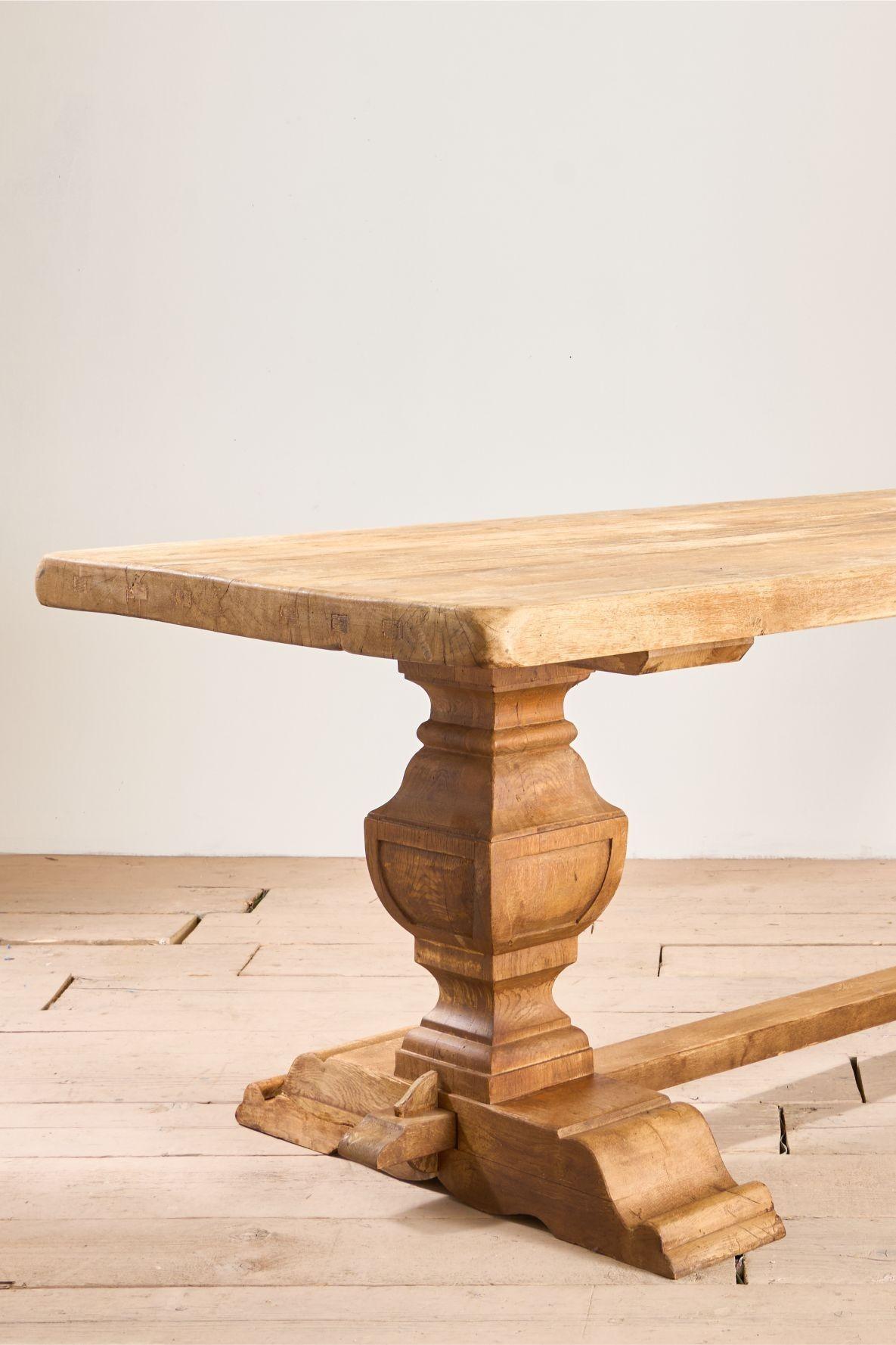 This is a fabulous, very heavy solid oak French dining table. The top is planked and beautifully patinated from years of use. The thickness of the top is also very impressive. The planks are biscuit jointed together which is a wonderful detail