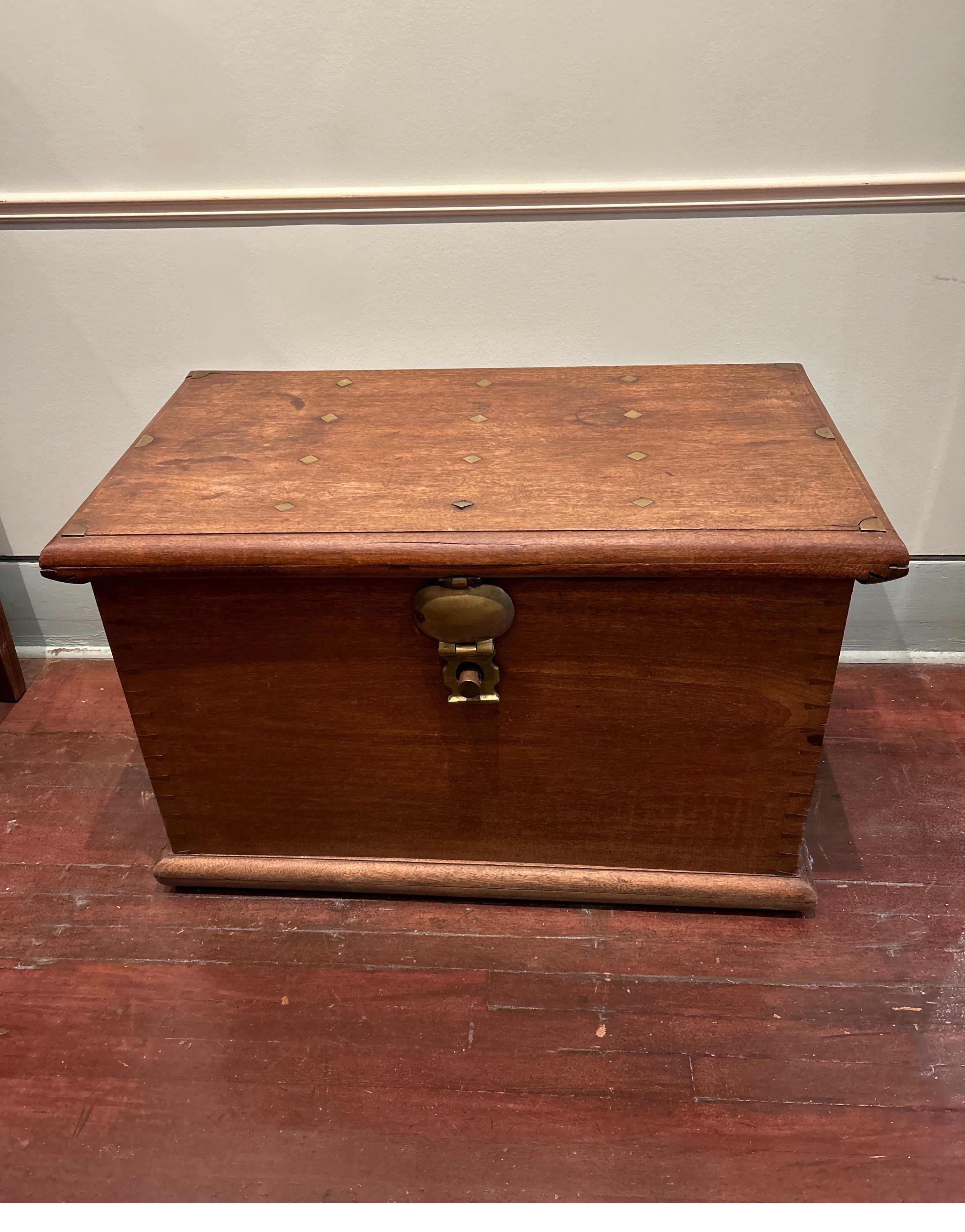 Rare, solid Dutch Colonial teak and brass strongbox. This chest is built like the vault it was meant to be. Heavy, strong wood and weighty hardware including cast iron handles and hinges adorn this uncompromisingly crafted strong box that was likely