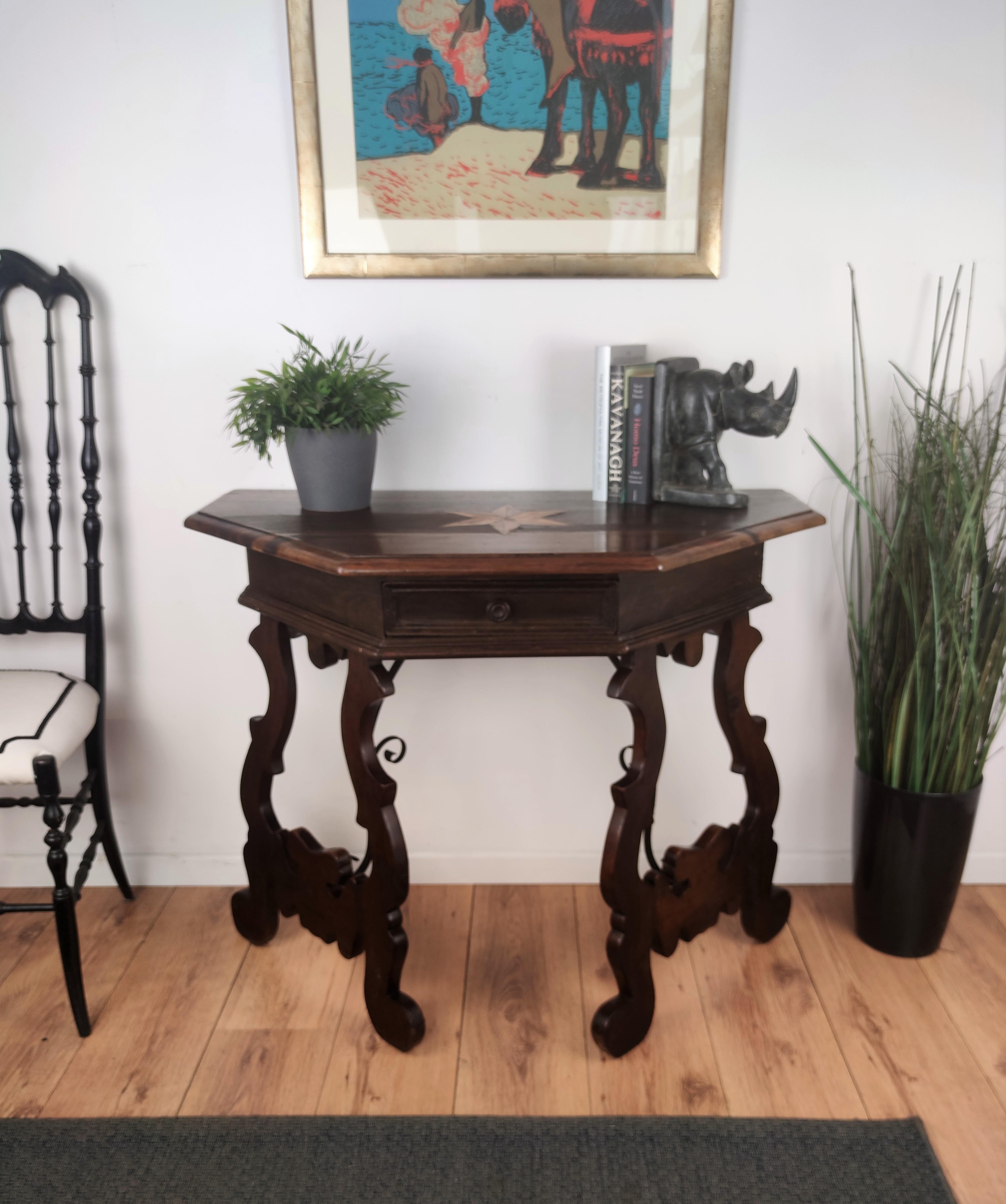 A beautiful 19th century baroque console table made of solid walnut with lyre shaped legs joined by wrought iron stretchers. Inlay decoration on the beveled top and a central drawer on the front. Beautiful grain and nice character to the wood with