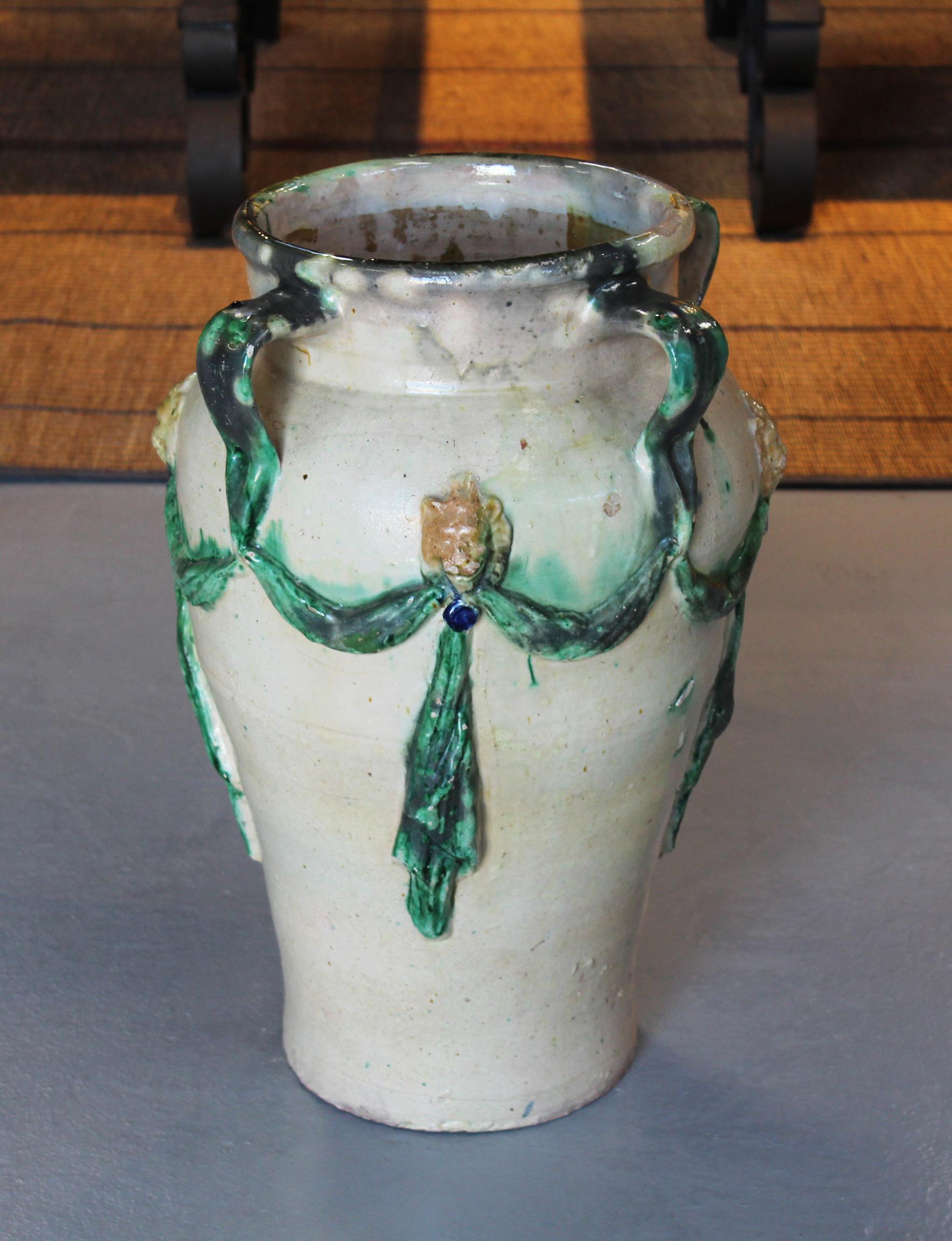 19th century Spanish Andalusian white glazed ceramic vase decorated with green garlands and yellow lion heads.