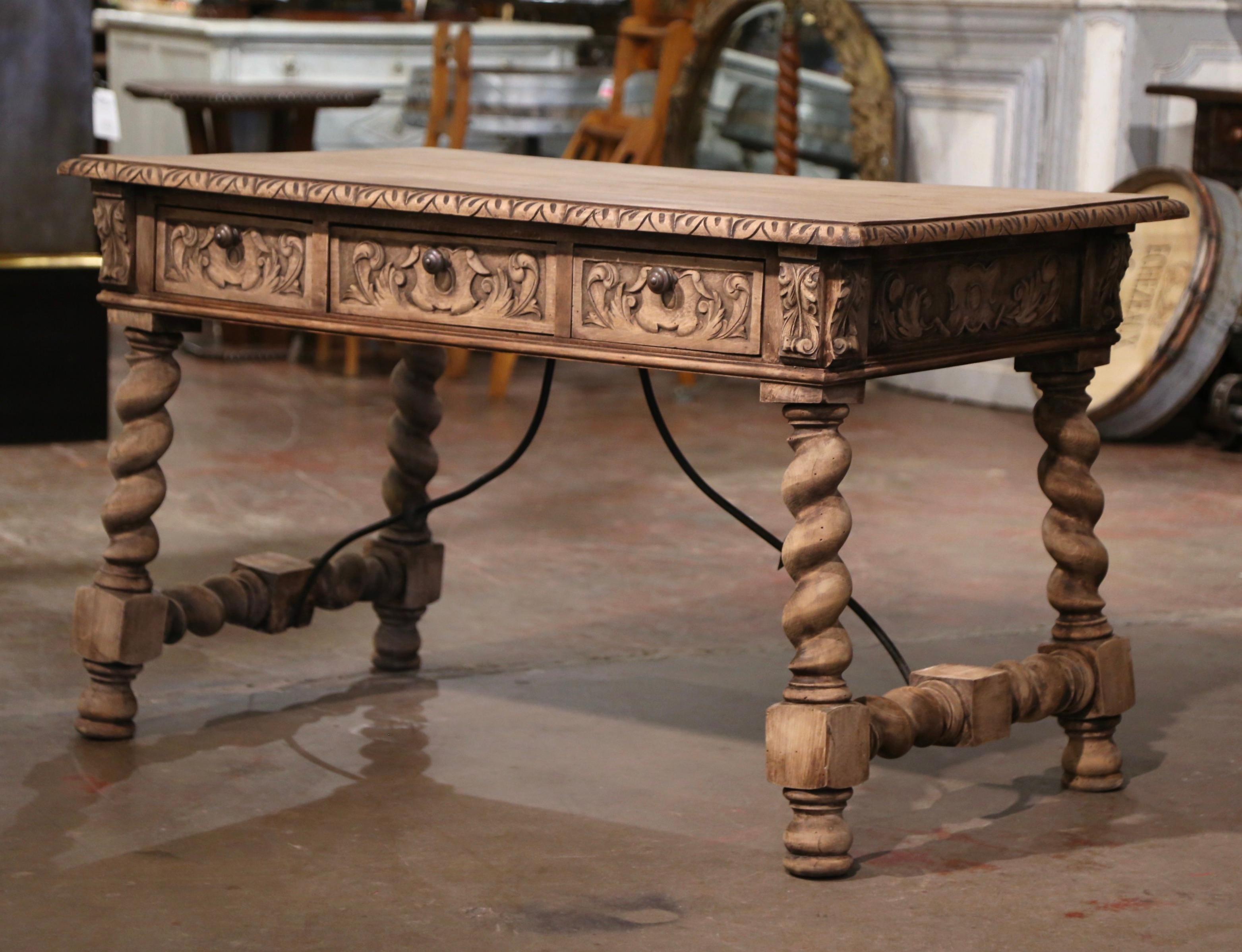 Add a focal point to your study or library with this elegant antique fruitwood desk. Carved in Spain circa 1870, the tall trestle table stands on four carved barley twist legs ending in round feet, and connected with a decorative forged iron