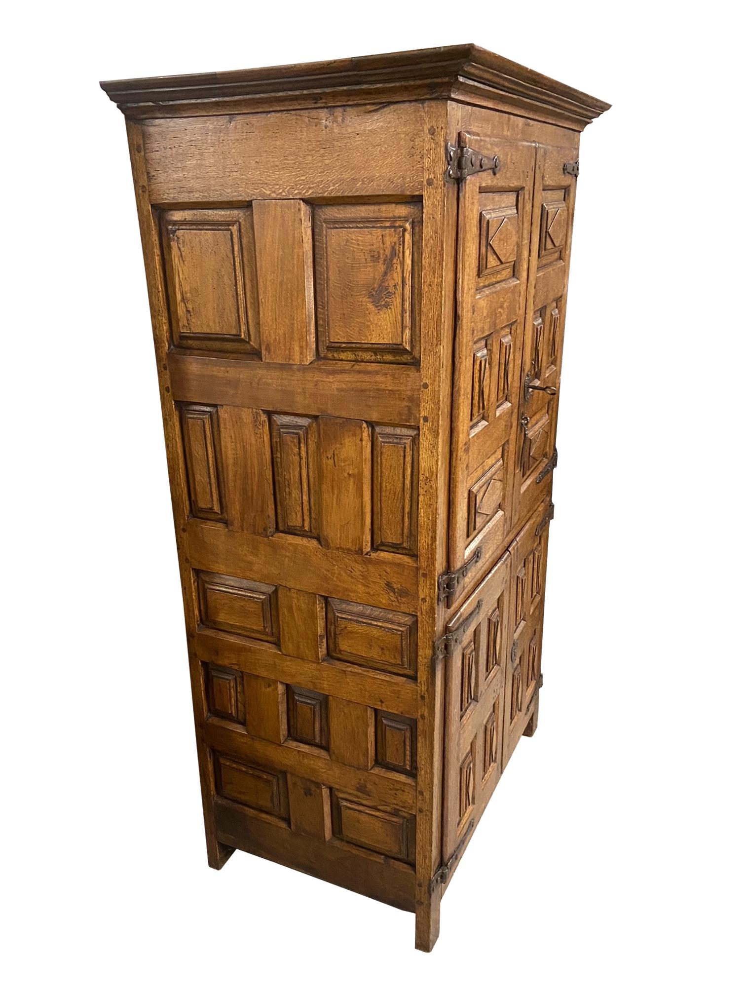Solid oak cupboard from Northern Spain.
Two doors with geometric paneling.
Iron hardware with original keys.

Dimensions:
81?H x 26.5?D x 53?W.