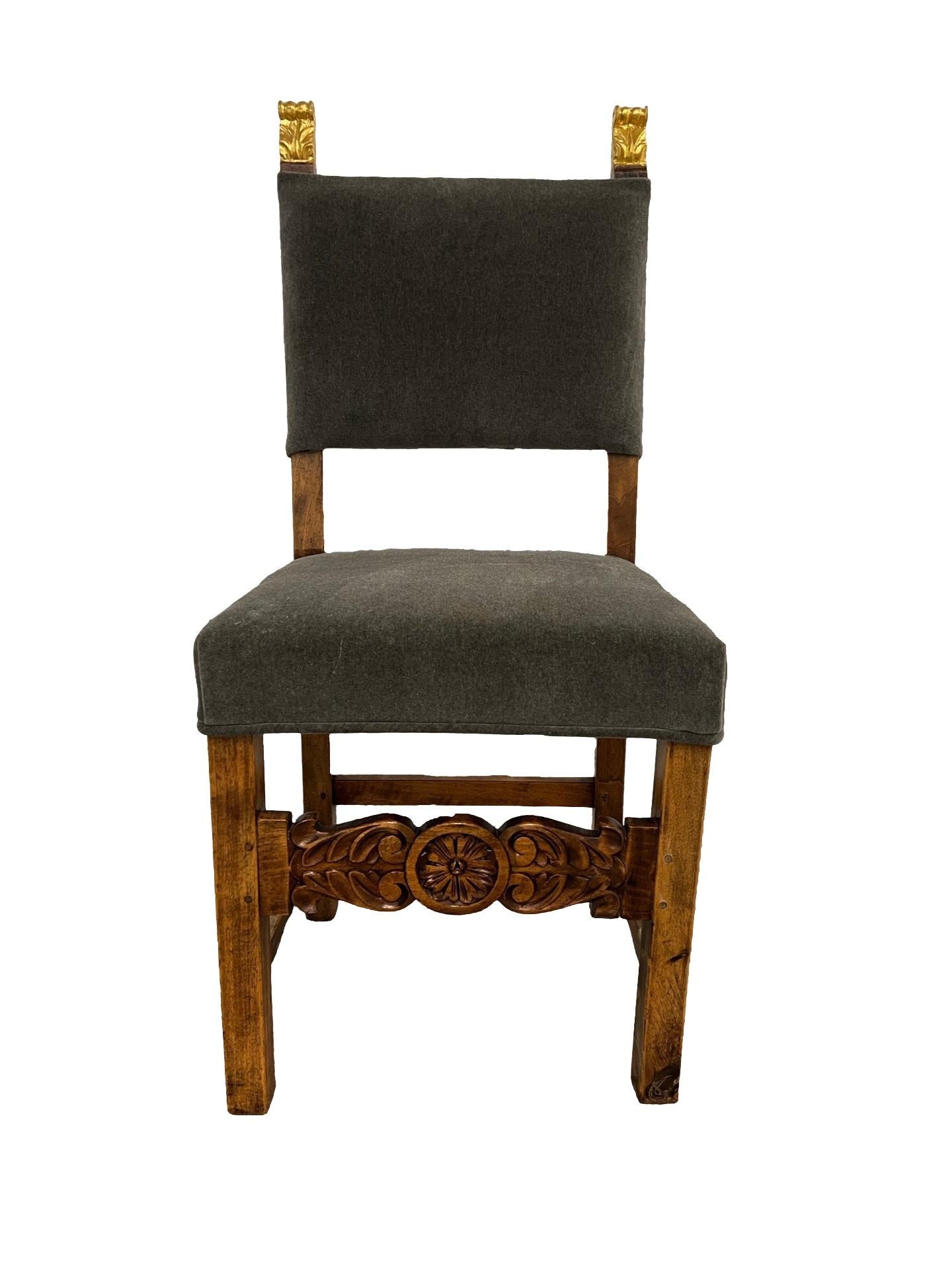 Spanish, early to mid 19th century.

A very attractive antique Spanish side chair with gilt wood finials, carved skirt rail and upholstered with a gray mohair fabric back and seat. 

Measures: 34.125