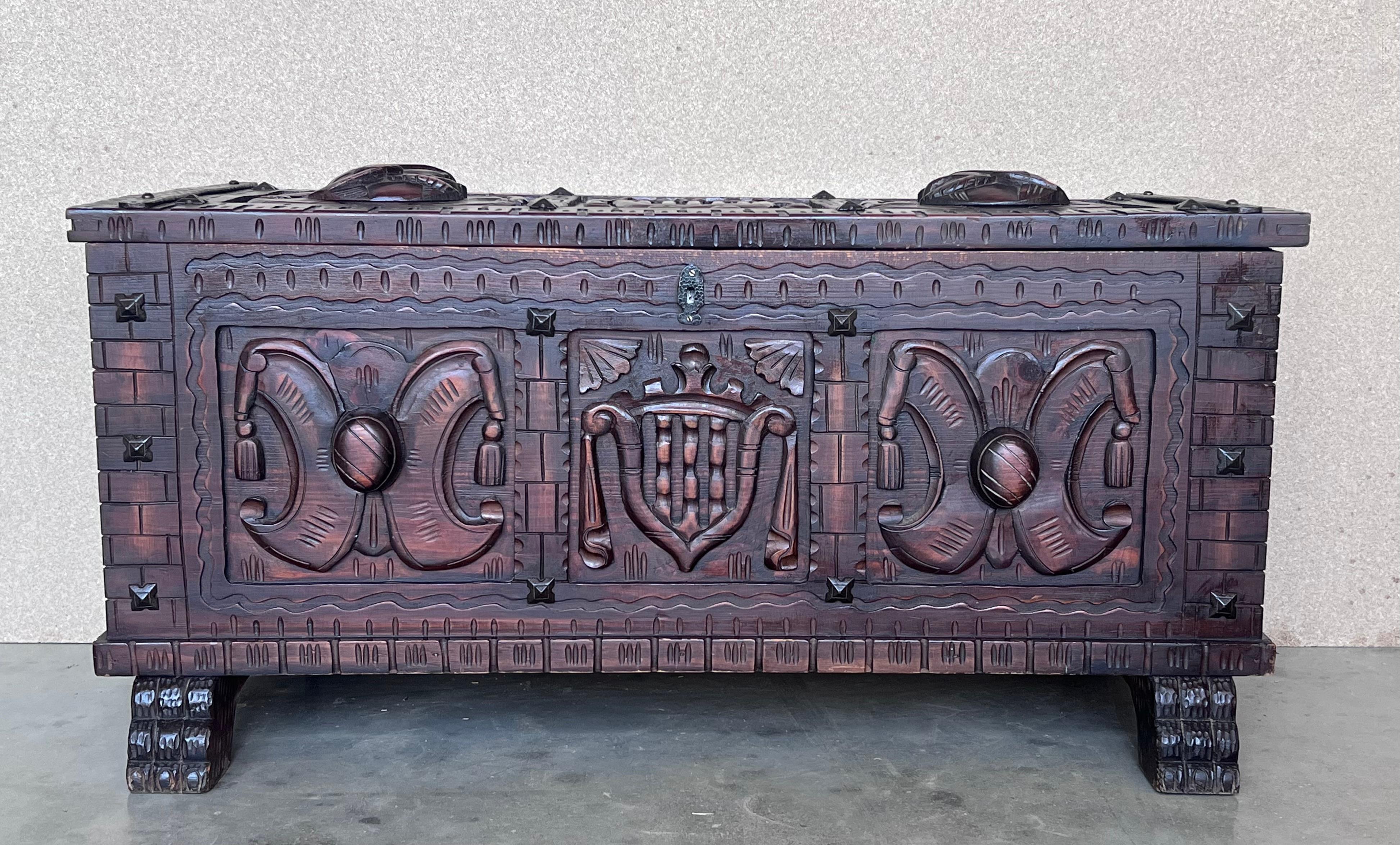 Nice 19th century chest in walnut. Hand carved facade panel with heads decorations. Plinth with brace decorations, dovetail assembly with wrought iron wardware.
Add a real show stopper to your interior with this extremely Spanish chest or coffer,