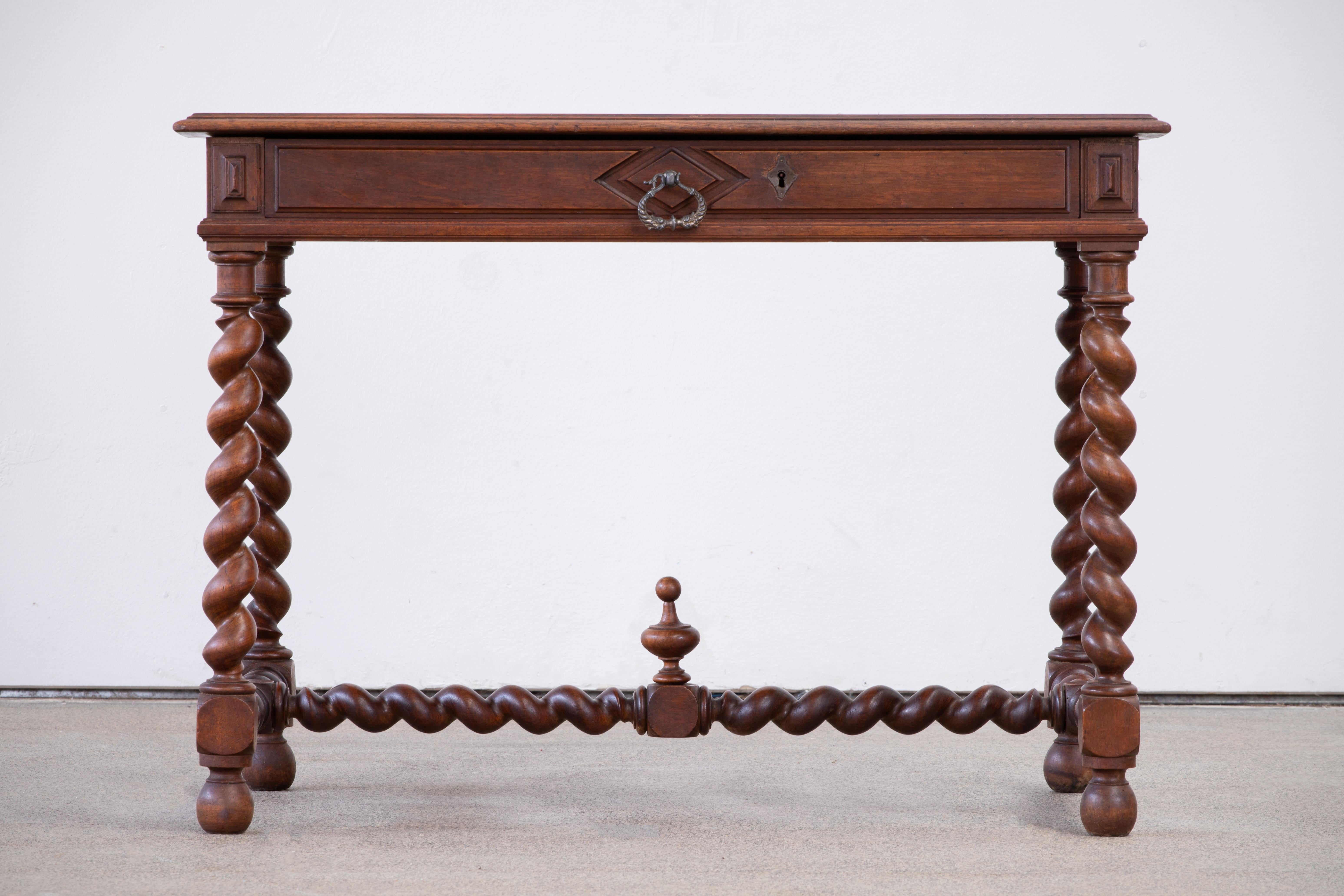 19th century Spanish antique oak desk, writting table with two drawers.
This elegant console was crafted in Spain, circa 1900, it features hand-carved details and turned legs. 
The narrow console is in good condition with a rich patinated