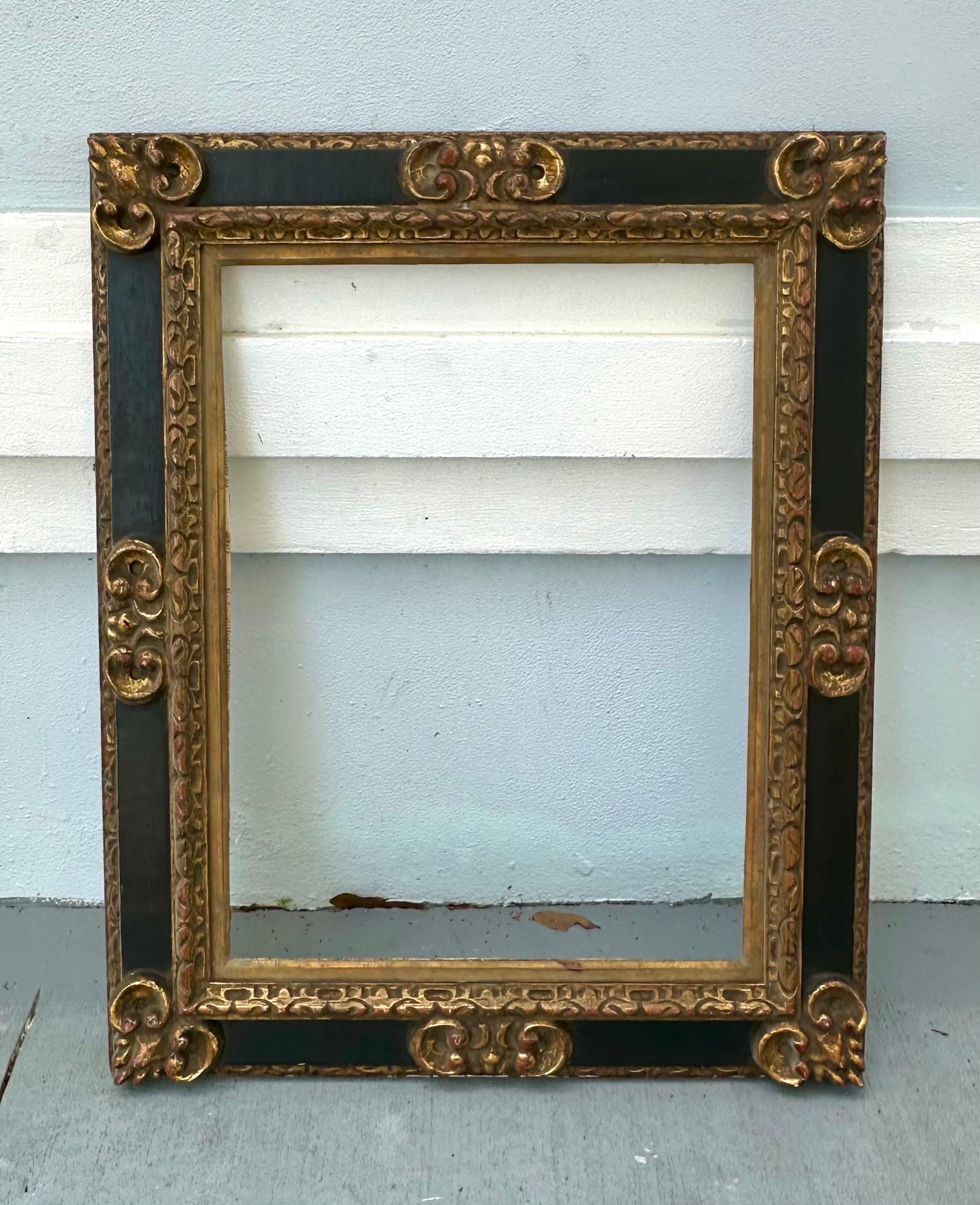 19th Century Spanish Baroque Style Frame

Solid wood carved frame, applied with gilt mouldings. The ebonized border is decorated with gilt foliate scrolls. The frame is covered in verso with antique printed book pages. Spanish frames are known for