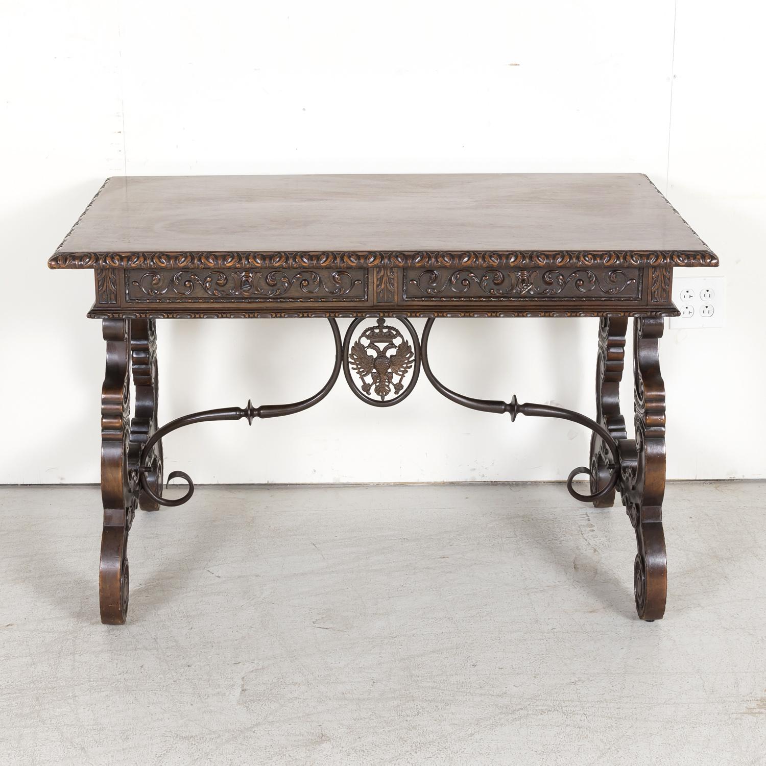 A finely carved Baroque style writing table or side table handcrafted of walnut by talented artisans in the Catalan region of Spain, circa 1880s. Having a single plank rectangular top with a beveled gadroon edge above an intricately carved frieze