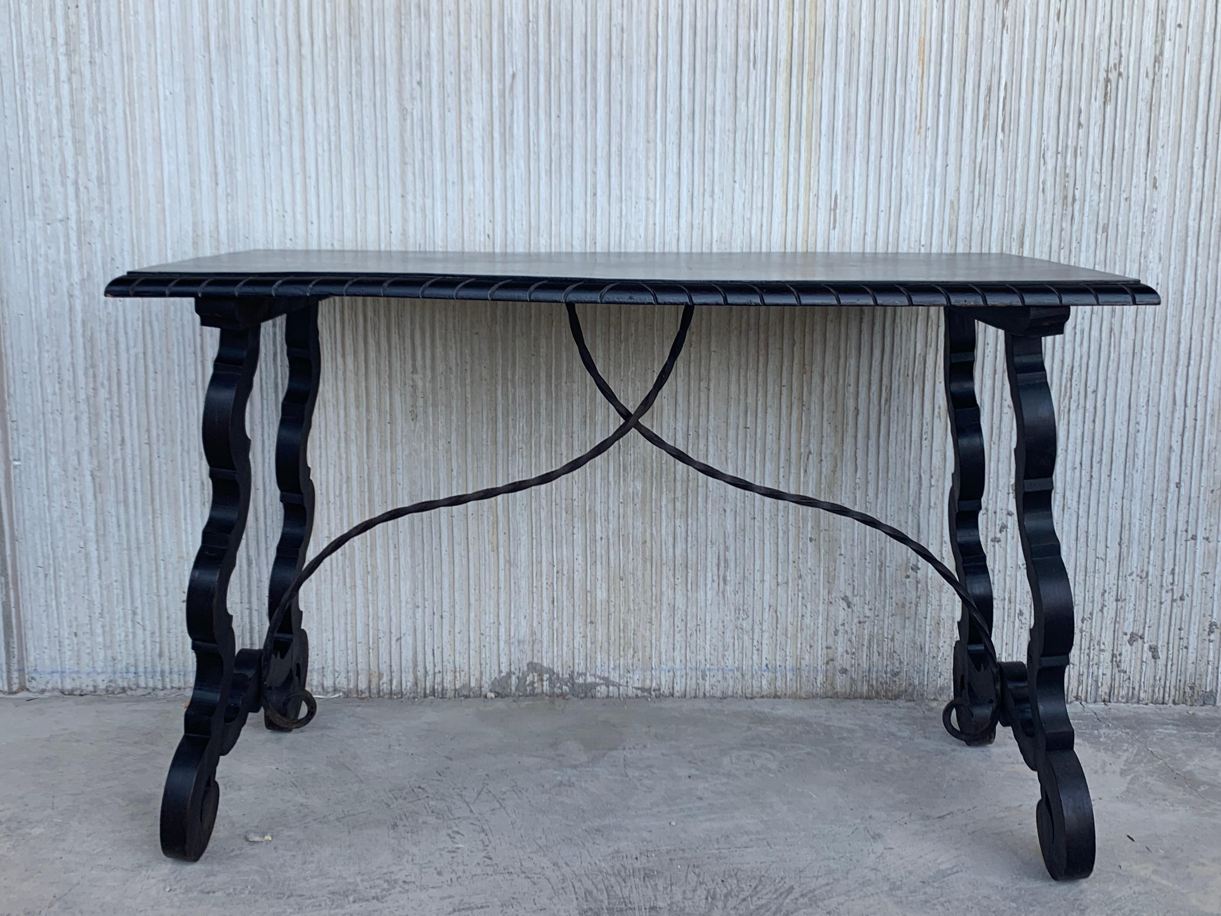 This chestnut refectory table with lyre or harp form supports and original iron stretchers. Its robust but elegant style will definitely stand out in your home or office. 

A refectory table is a long narrow table supported by heavy legs or