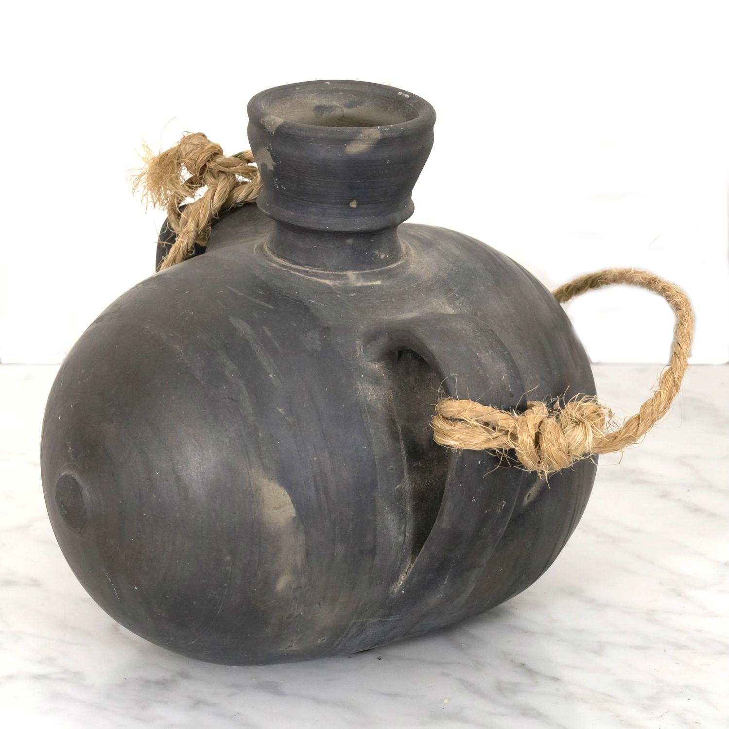 A signed 19th century barro negro or black clay tonel or barrel hand made in Miranda de Avilés in the Asturian area of ​​the Cantabrian coast of northern Spain, circa 1890s. This beautiful signed utilitarian pot, with its barrel shape, wide mouth,