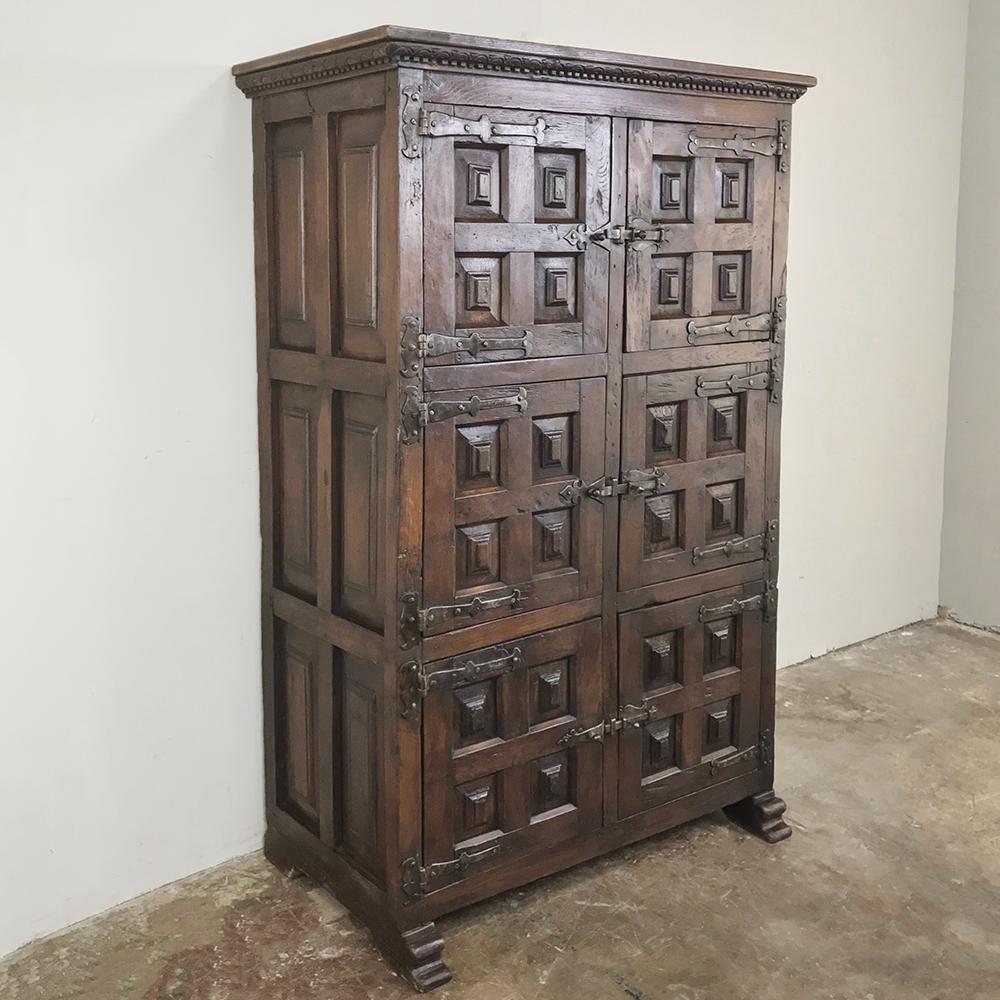19th century Spanish cabinet was designed as a kitchen cabinet, and created from framed heavily chamfered panels affixed to the casework with massive hand forged strap hinges. Six such panels appear on the sides! Big cross bolt latches secure the