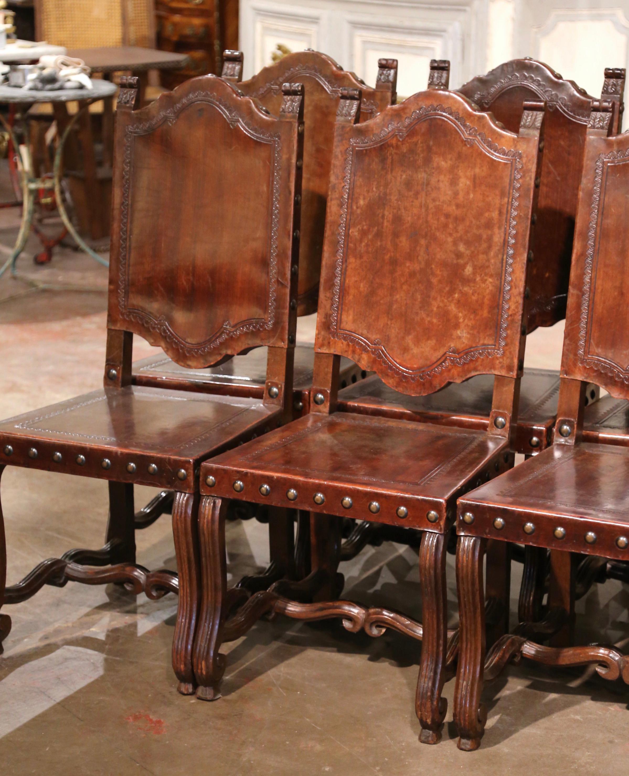 Louis XIII  19th Century Spanish Carved Walnut Chairs with Embossed Leather, Set of Eight