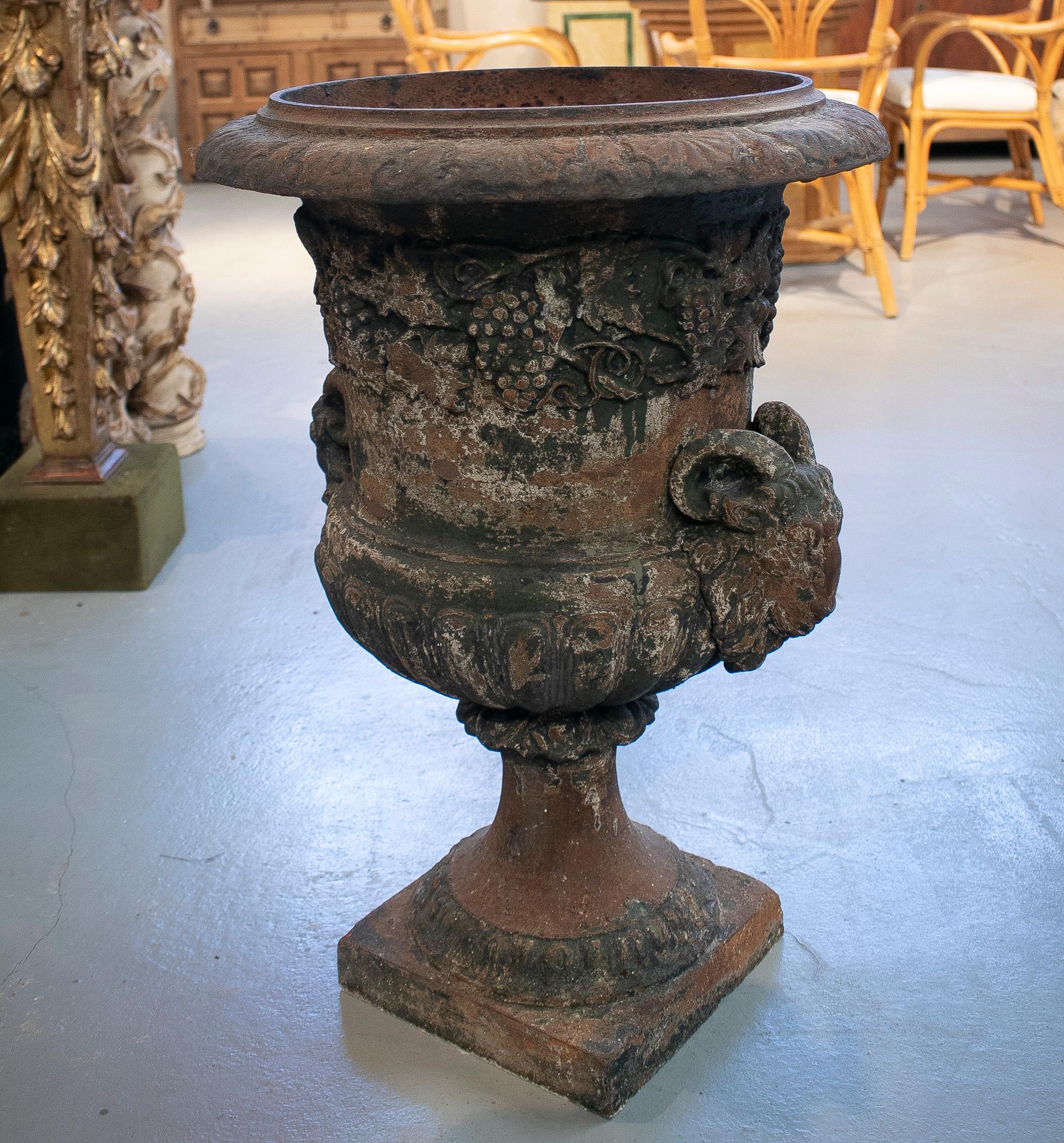 19th century Spanish cast iron painted garden urn planter with goat heads.