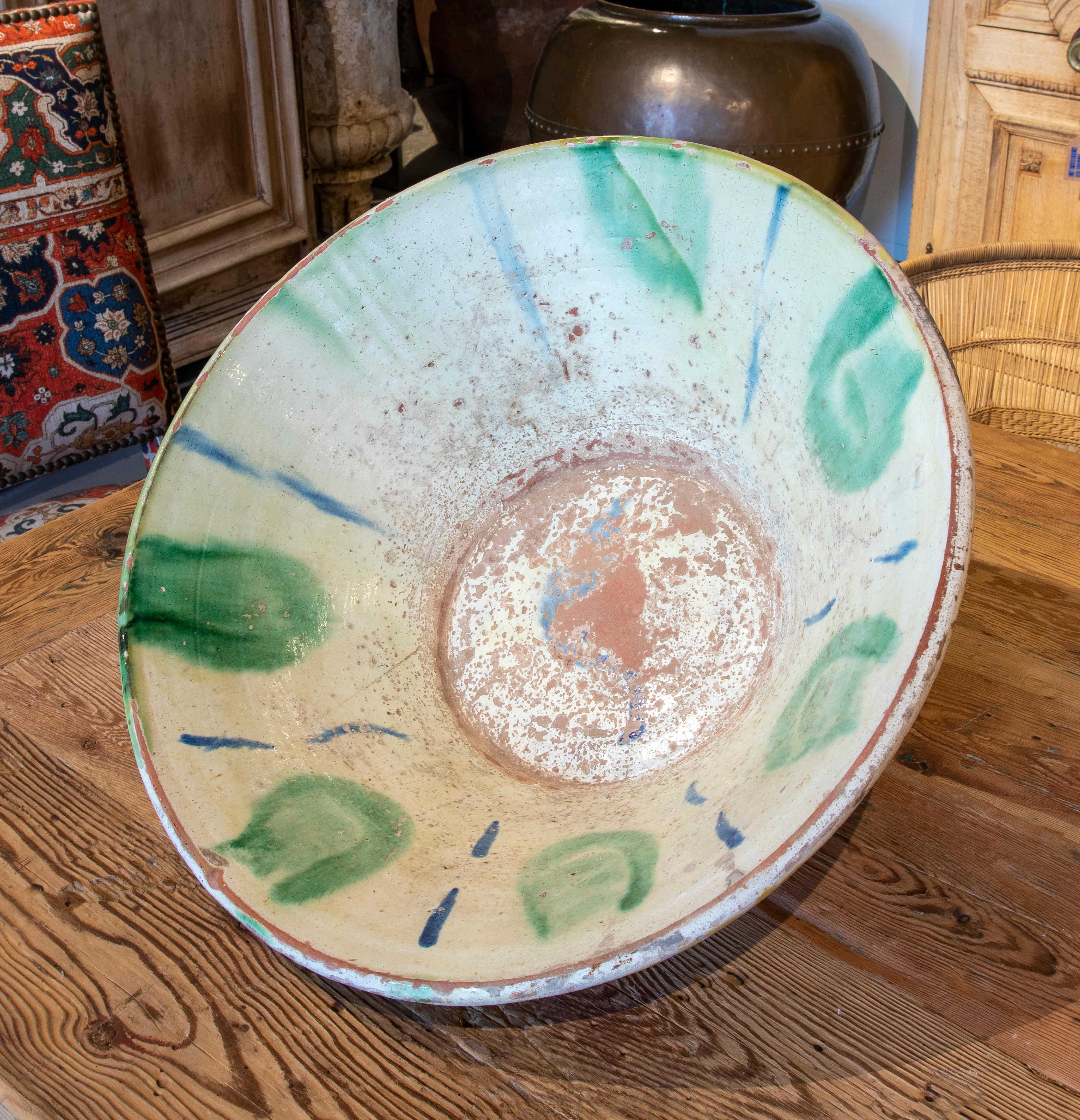 19th Century spanish ceramic basin hand painted and glazed in green tones.