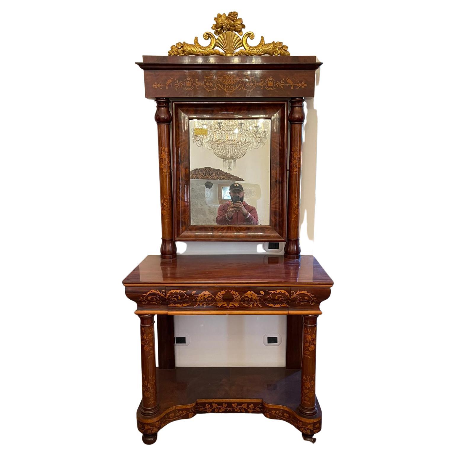 Spanish console table with mirror, Charles X era (1815-1830), mahogany wood and boxwood and maple inlays. Fully inlaid columns support a tilting mirror, surmounted by a cymatium formed by two cornucopias supporting a shell with a floral composition