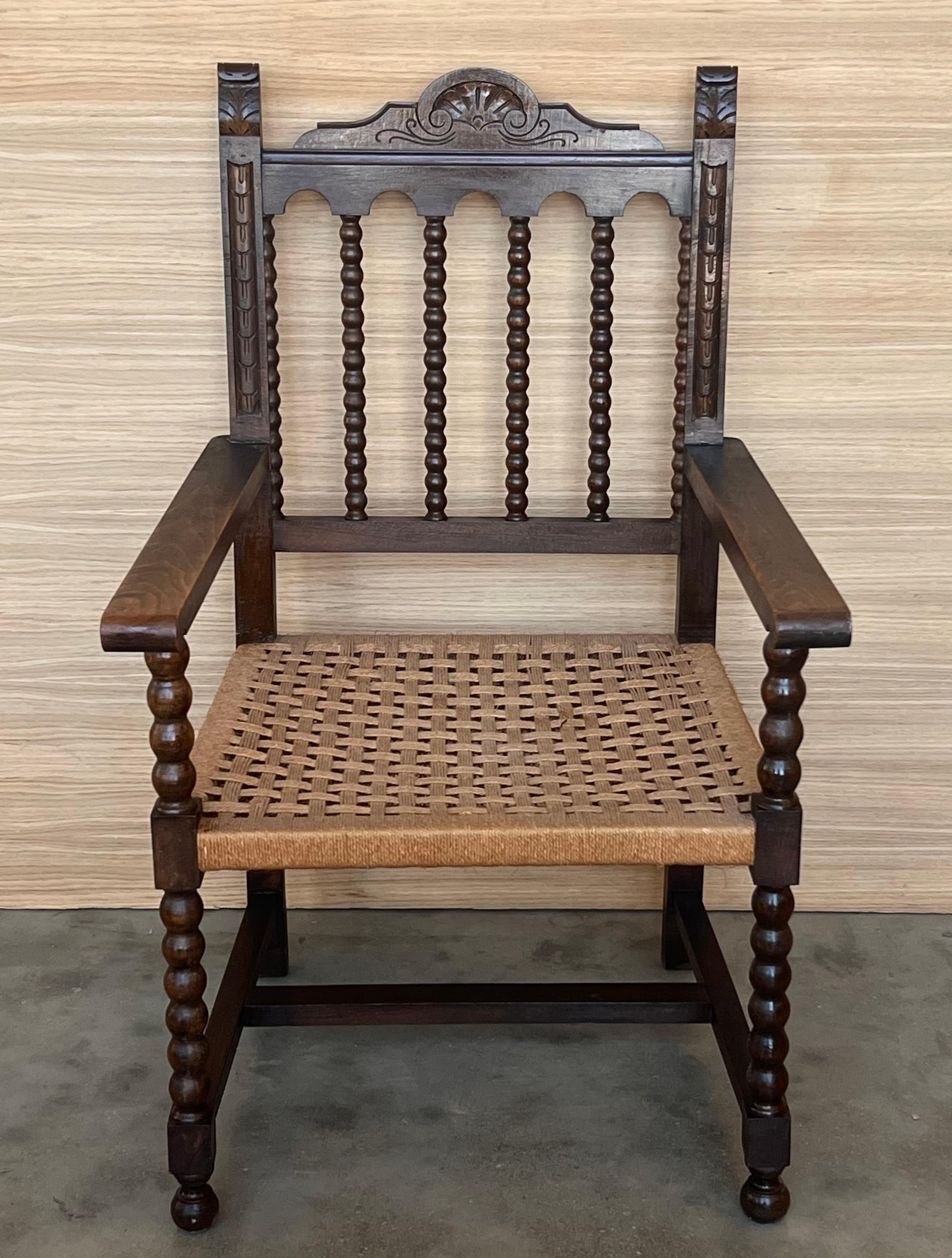 19th century Spanish colonial altar armchairs with wood seat with ornamental carved on the back and beautiful Solomonic legs. There are a very resistant and heavy armchairs.

Measures: Height to arms 25.19 in.
