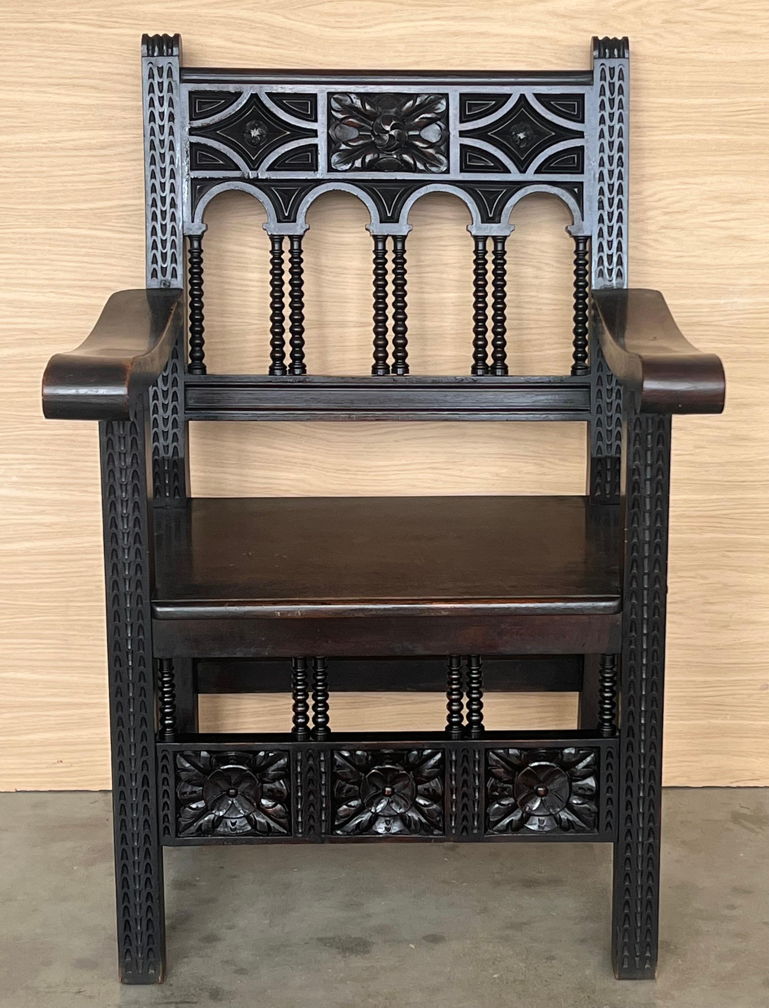 19th century Spanish colonial altar armchairs with wood seat with ornamental carved on the back and beautiful legs and armchairs. There are a very resistant and heavy armchairs.

Measures: Height to arms  74.5cm