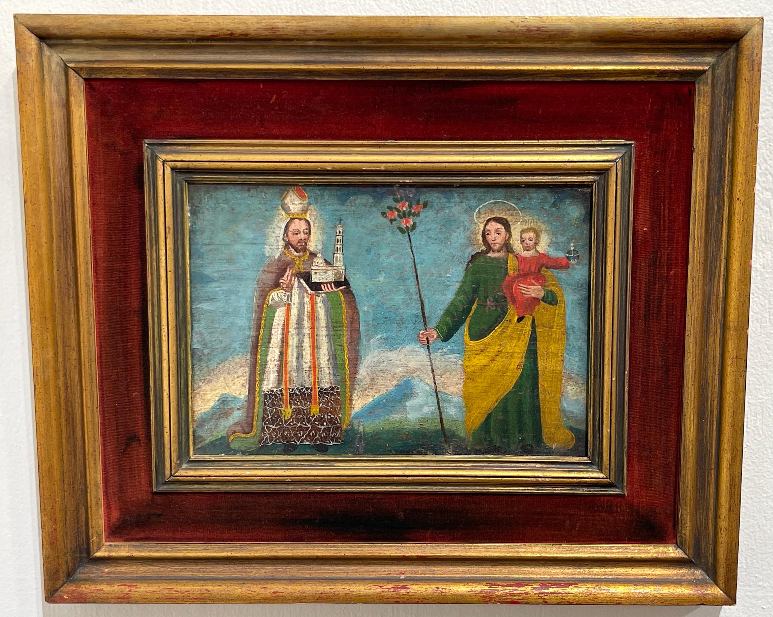 19th Century Spanish colonial Icon /Retablo saint & christ & child landscape.
Painted on Board, in a later giltwood & inset velvet frame.

An atypical depiction of a standing saint holding an architectural model of a 
la iglesia to the left, the