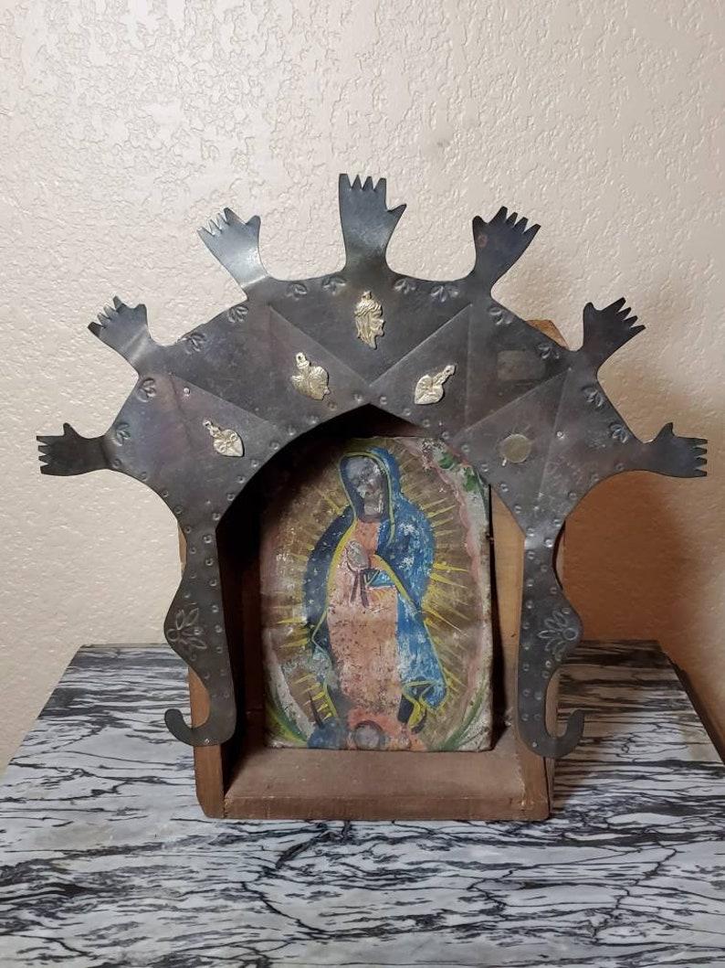 A stunning and rare Spanish Colonial Our Lady of Guadalupe retablo painting with beautiful patina, displayed in an altarpiece shrine. Handcrafted around present day New Mexico during the early to mid 19th century, the unframed antique religious