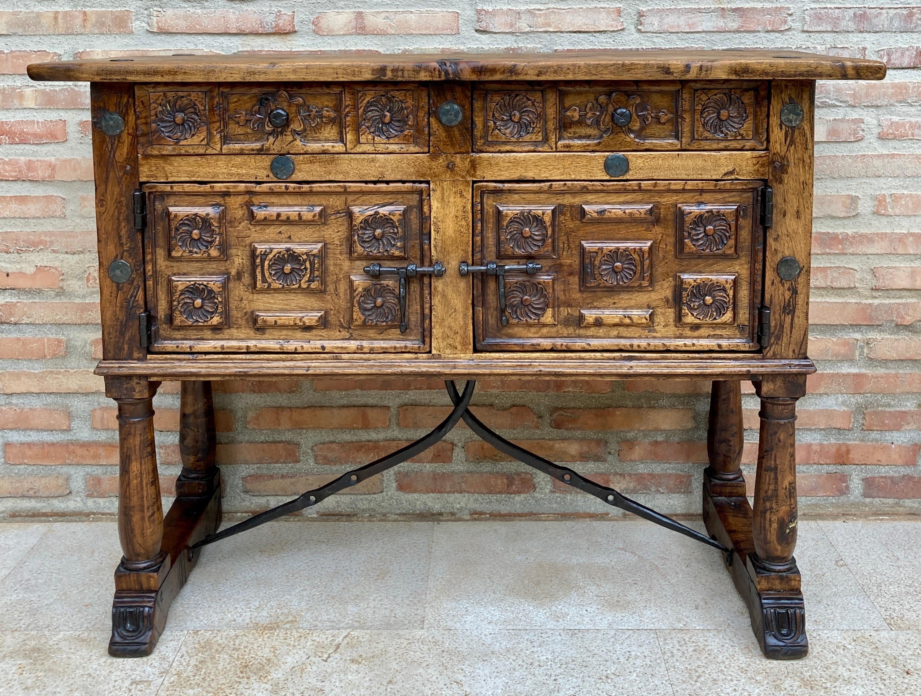 Antique 19th century Spanish console table in walnut with two drawers, a central door and original iron fittings. 
It can be used as a dresser or chest of drawers. 
This elegant console table was made in Spain, circa 1890. The four-legged sofa