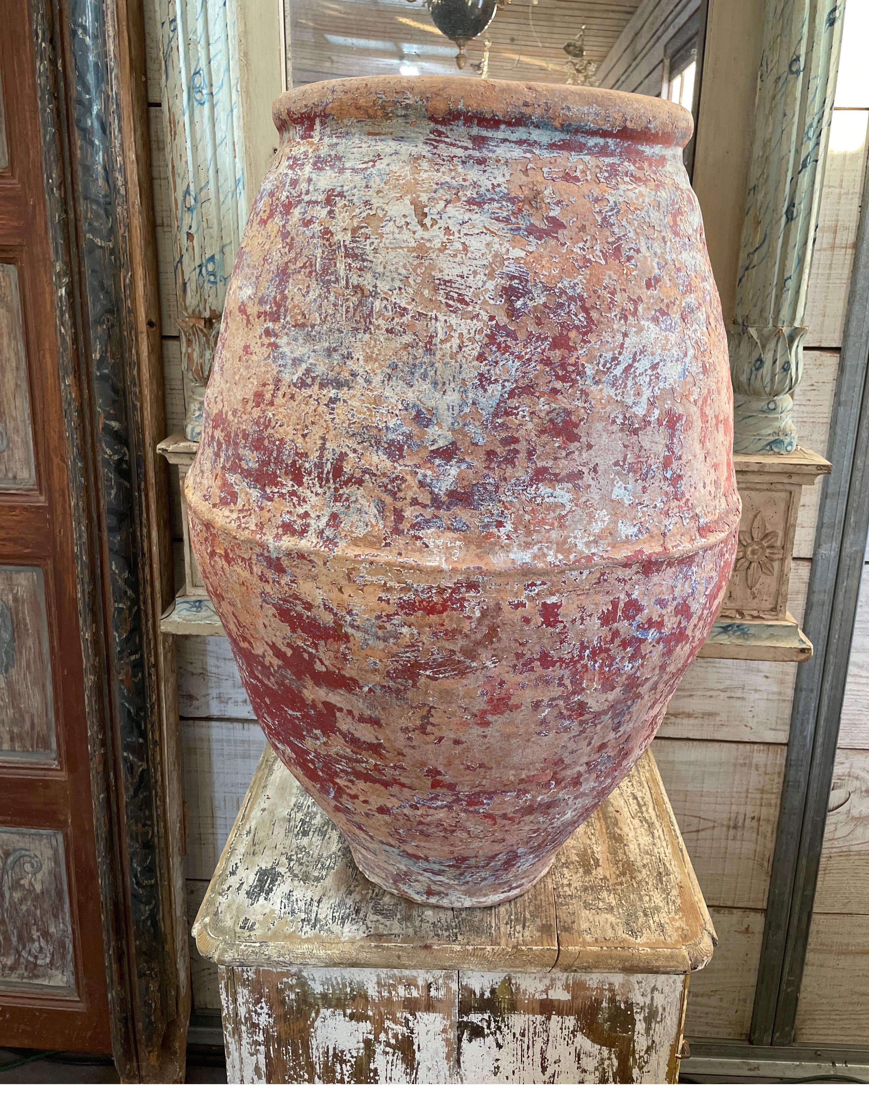 This olive jar has remnants of the deep dark red paint as well as traces of blue. It’s great used as a sculpture in a room or outside in a garden setting. Measures:23 inches wide x 34” tall x 15-5” top of mouth and base bottom is 10” W.