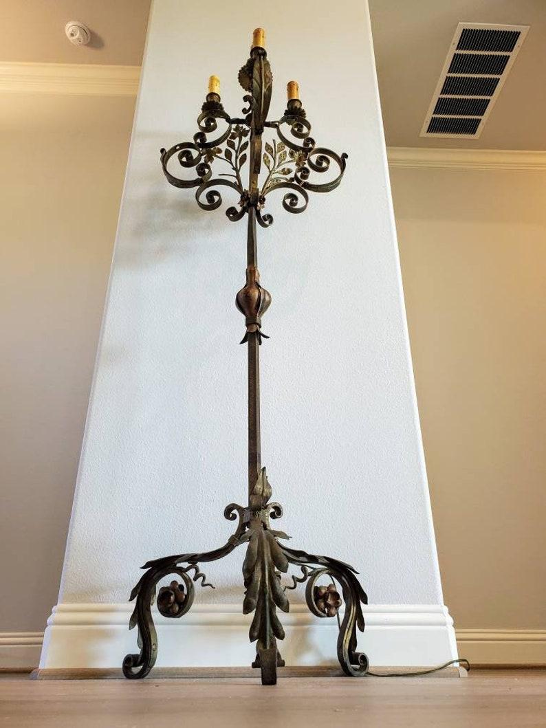 A magnificent antique Spanish Colonial style wrought iron tall floor standing candelabra attributed to legendary Palm Beach designer and all around interesting character Addison Mizner (American; 1872-1933)

Hand-crafted in the early 20th century,