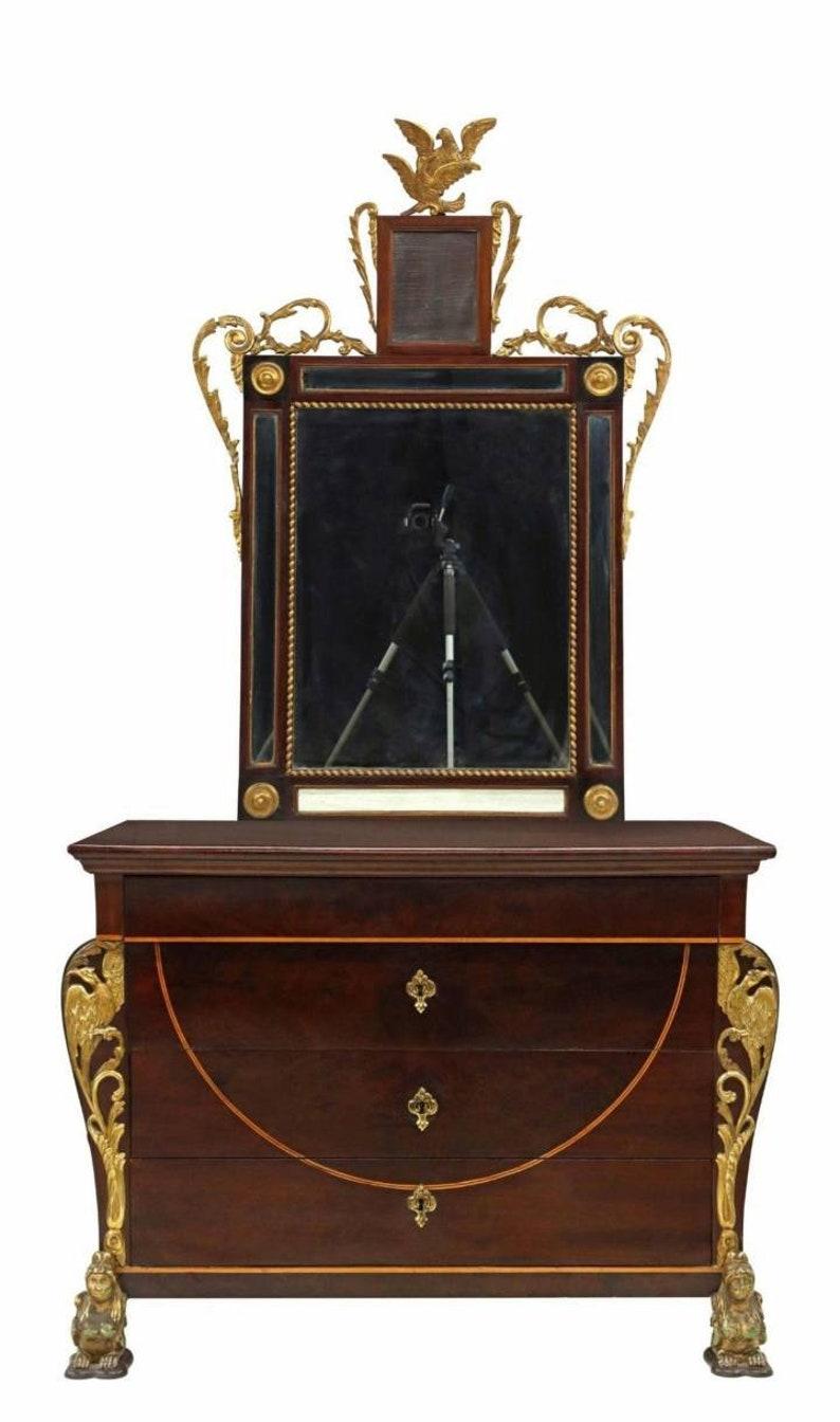 A rare and magnificently decorative antique Spanish Fernandino style mahogany chest of drawers commode and mirror. 

Hand-crafted in Spain in the late 19th century, surmounted by the monumental dresser mirror with finely hand carved giltwood bird