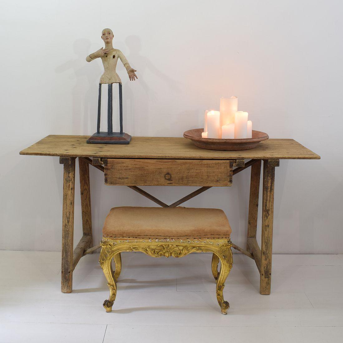 Beautiful gilded Louis XVI style carved stool or tabouret. The base and its gently curved legs are elaborately carved in a rococo fashion.
Spain, circa 1850, weathered, small losses and old repairs.
 