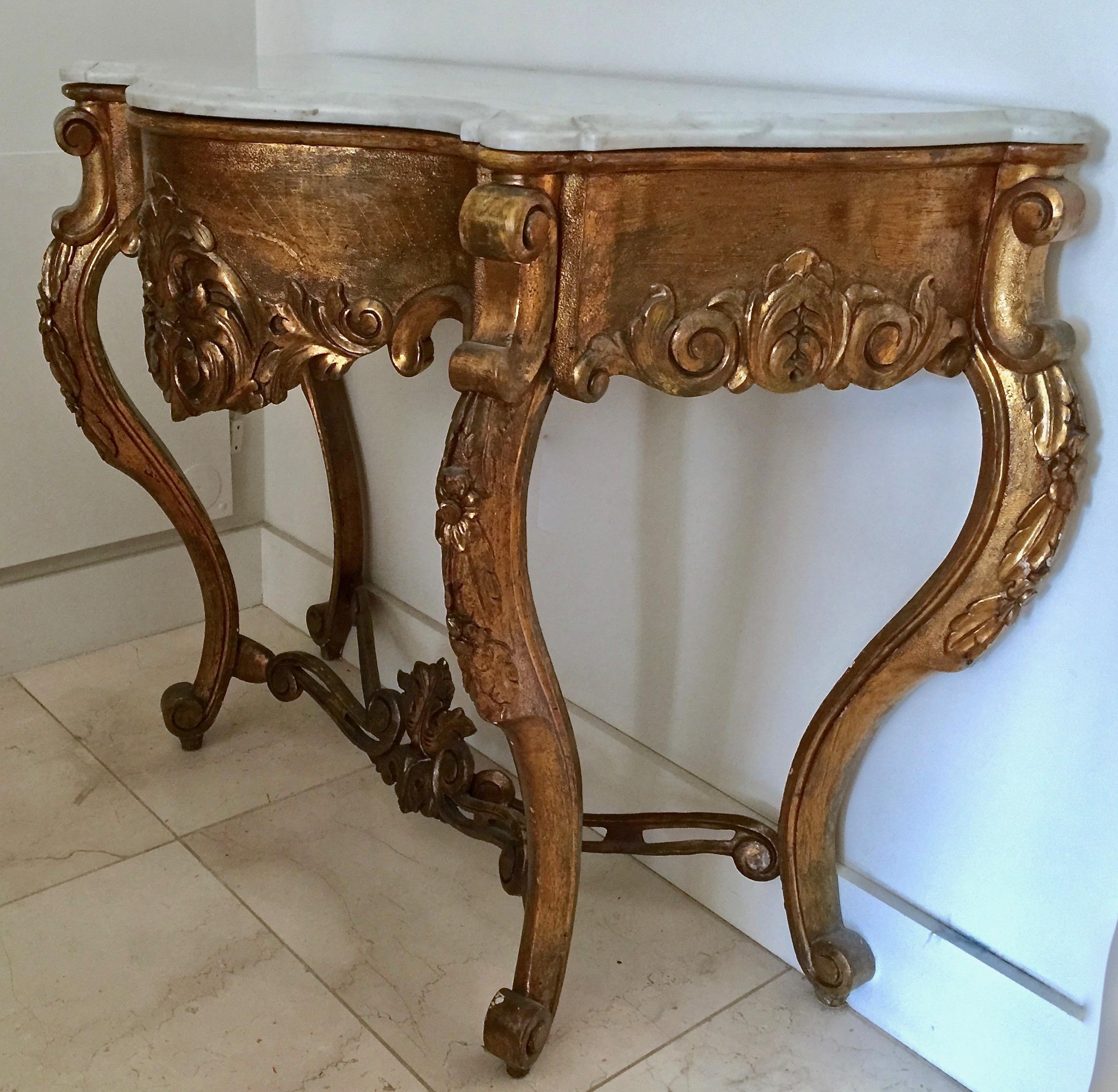 19th century Spanish console in lustrous gilt patina with richly carved frieze on graceful curved legs linked by an X-shaped stretcher decorated with scrolls and leaves and all topped with white original shaped marble.
Here are few examples …