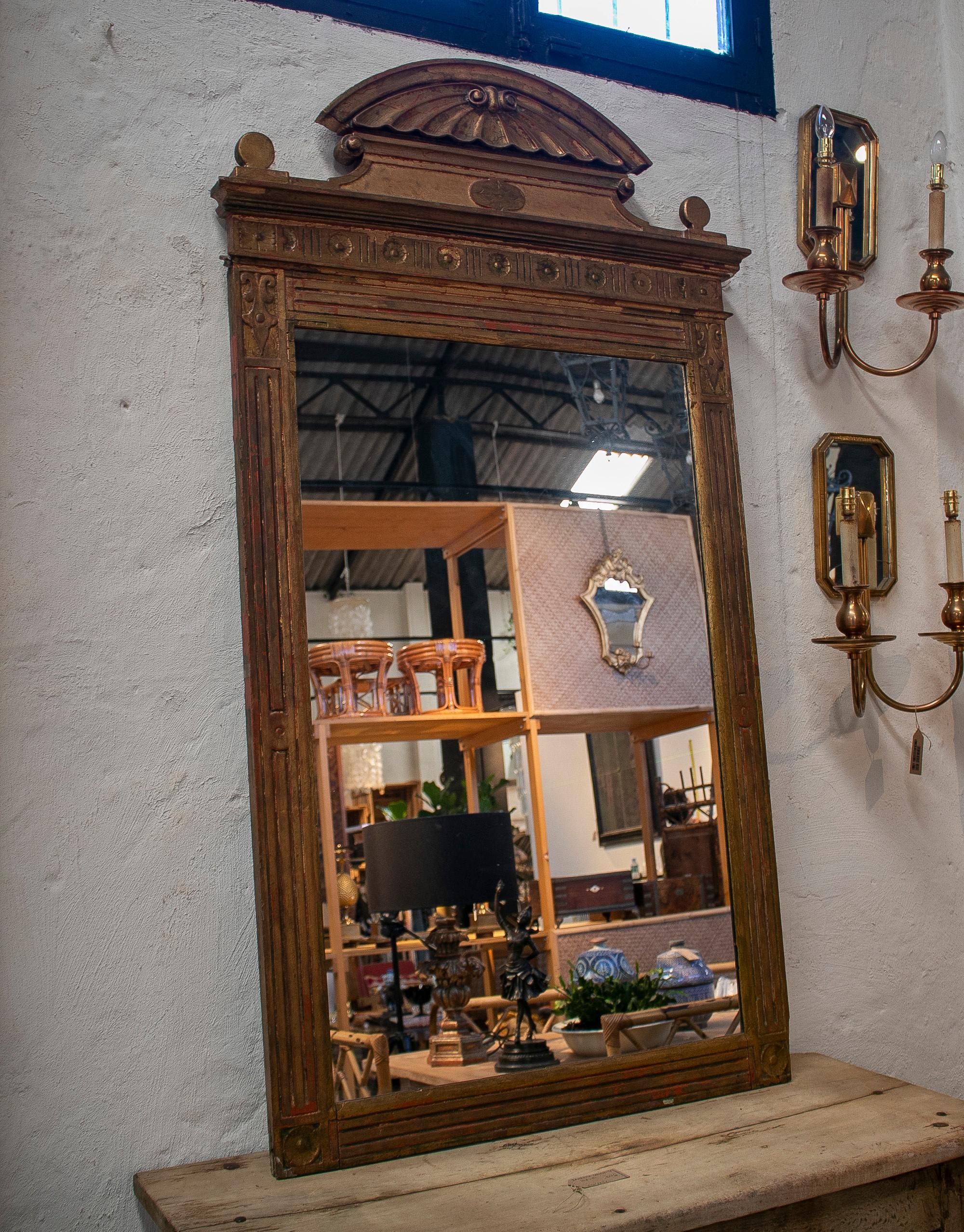19th century Spanish giltwood mirror with conch atop.