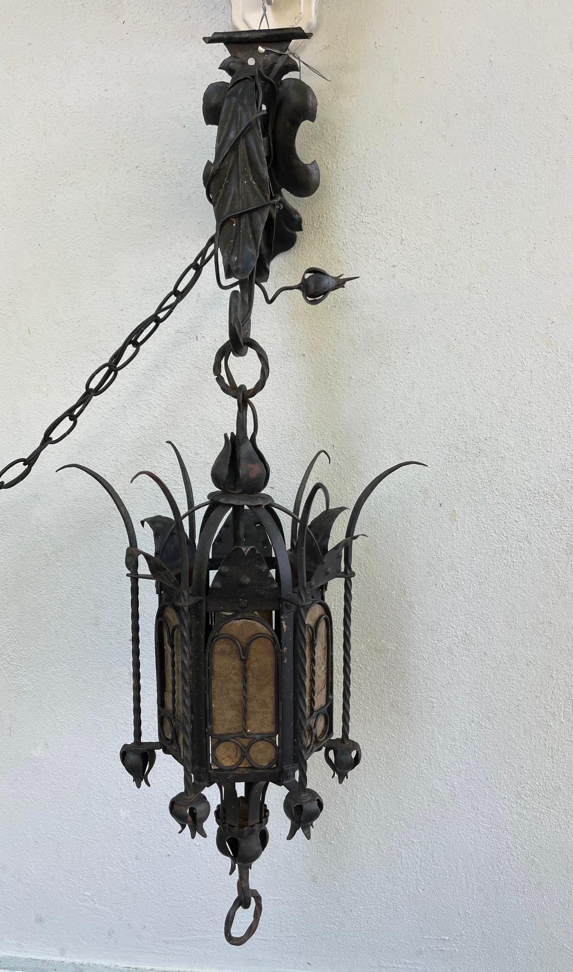 19th Century Spanish Gothic Style Wrought Iron Portico Lantern.

Antique hand forged iron Gothic style hanging lantern from Spain circa 1890. It is embellished with cut iron elements, spires and ring pull. The lantern comes with a decorative hanging