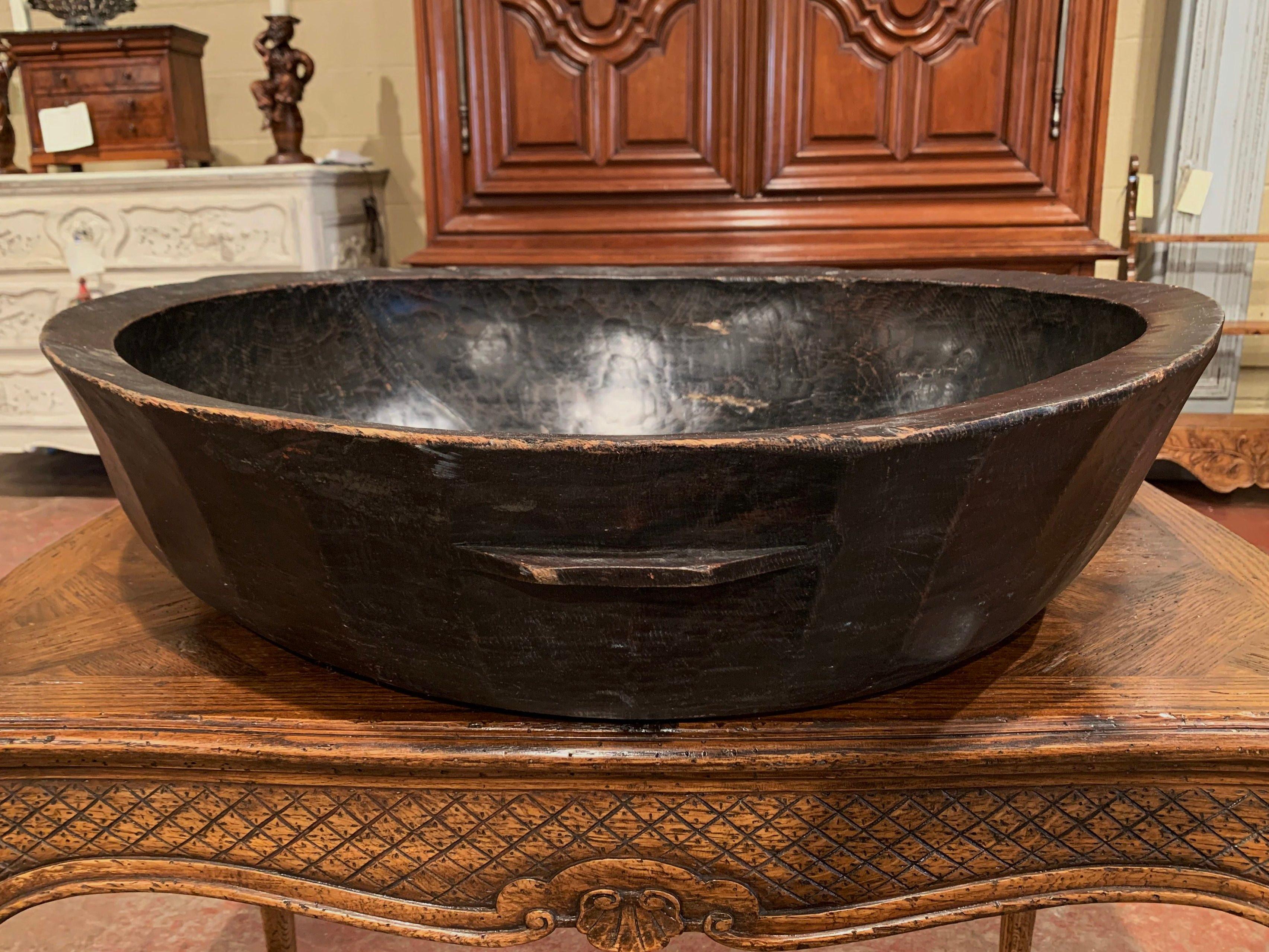 Fill up this elegant antique bowl with fruit and use it as a center piece on a dining room table! Hand crafted in Spain circa 1870, the large bowl in round in shape embellished with small handles and adorns a rich walnut patina.
Measures: 28.75