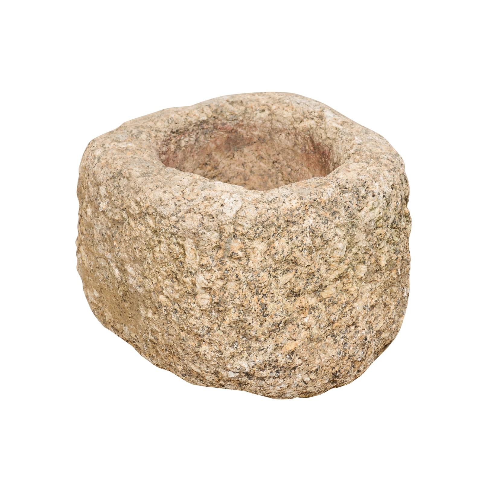 A Spanish carved stone trough from the 19th century. This antique trough from Spain, with it's rounded shape, has been hand carved out of a single piece of stone, having a nicely textured surface. This little trough would make a great way to display