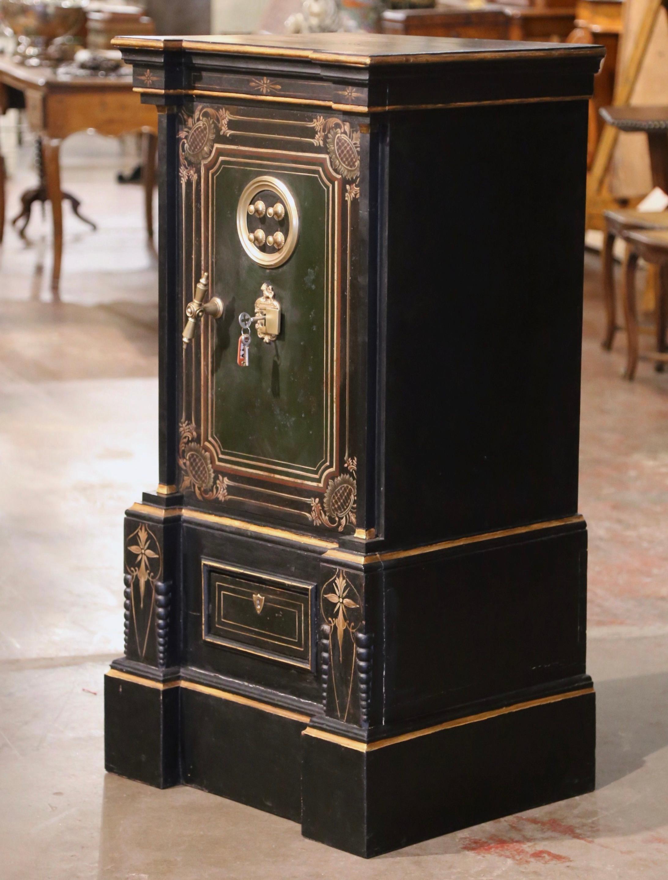 Keep all your valuables and jewelry safe in this elegant, antique iron safe. Crafted in Spain circa 1870, the strongbox features the original black color embellished with hand painted gilt floral decor. The massive safe has an impressive locking