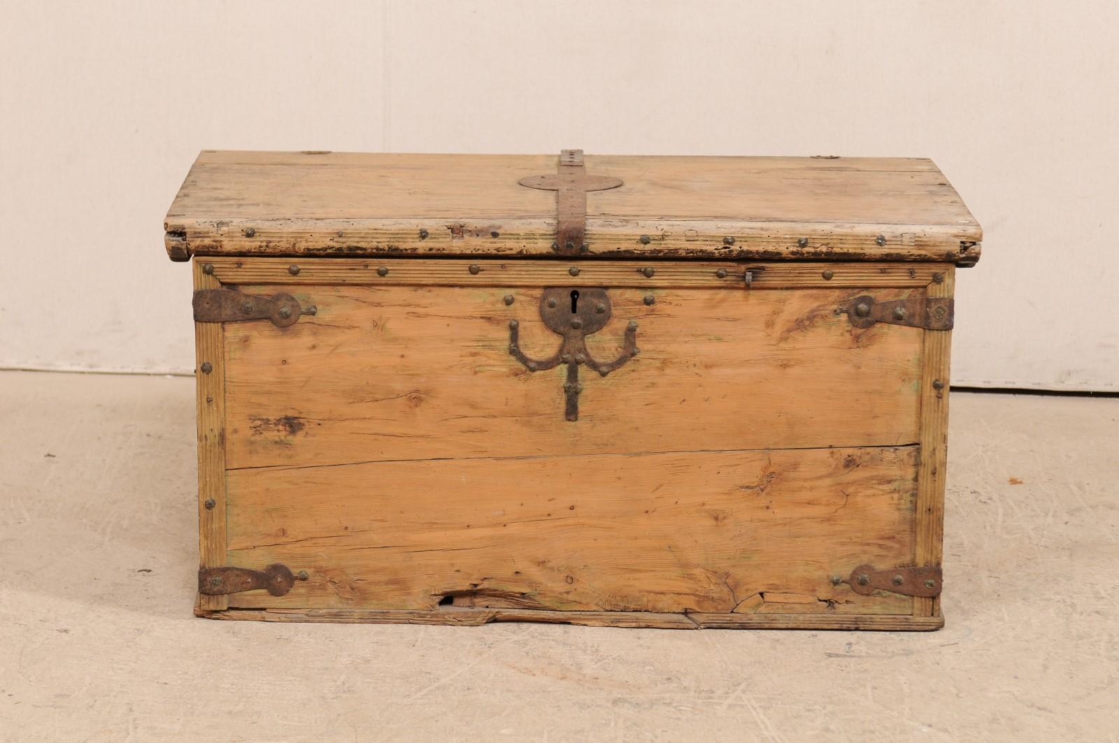 A Spanish 19th century light wood coffer or smaller-sized coffee table. This antique Spanish coffer, with it's rectangular-shaped body, has rustic appeal with it's light wood and nicely contrasting forged-iron hardware with fabulous patina. The top